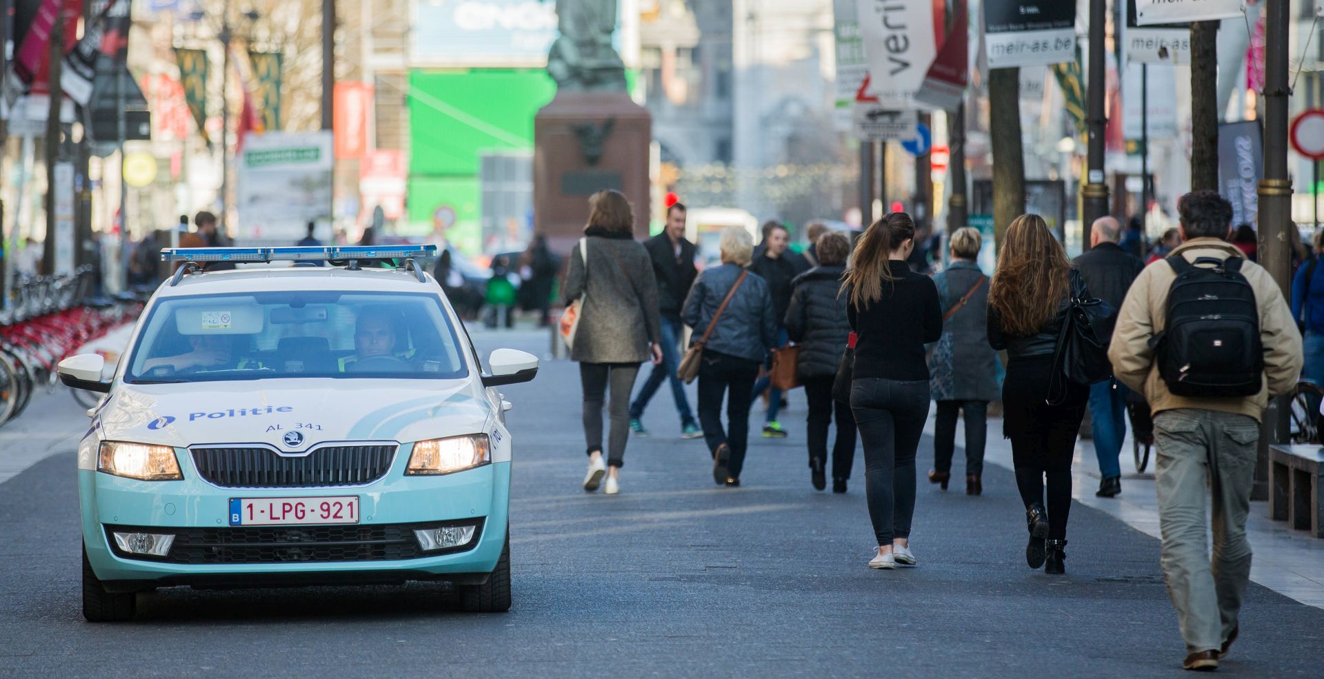 epa05866171 A police car patrols on the Meir, the main shopping street, after police arrested man on suspicion of driving at a crowd in Antwerp, Belgium, 23 March 2017. According to media reports, the police in Antwerp allegedly have arrested a man on the suspicion of attempting to drive into a crowd with his car. Belgian security forces found a rifle as well as bladed weapons in the car, driven by a French national, prosecutors said.  EPA/STEPHANIE LECOCQ