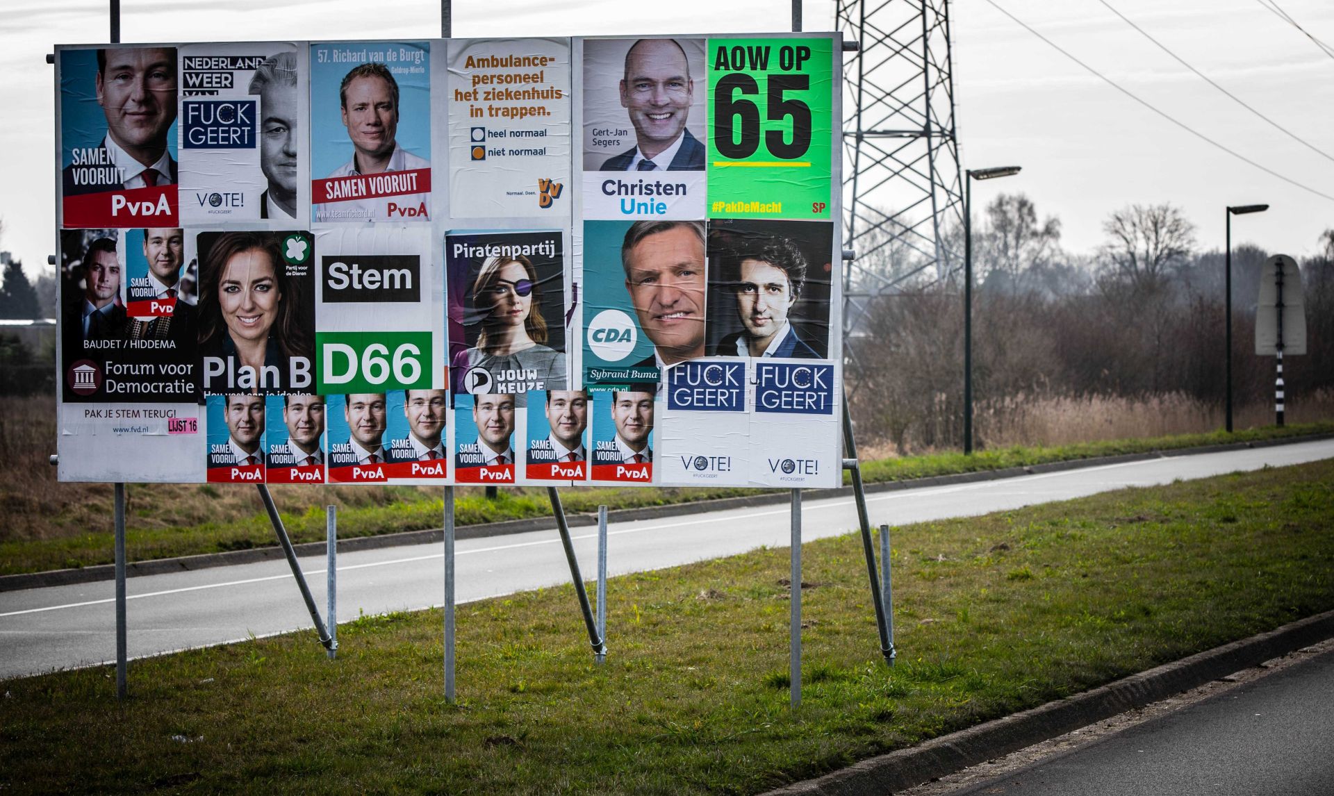 epa05850312 Election posters of the Dutch right-wing populist 'Partij voor de Vrijheid' (PVV) run by Geert Wilders, are pasted over with graphic language flyers, in Geldrop, The Netherlands, on election day 15 March 2017. Dutch voters go to the polls in the general election that has garnered international attention as Dutch Prime Minister Mark Rutte's center-right VVD party and Populist leader Geert Wilders' party are dominating the polls.  EPA/ROB ENGELAAR