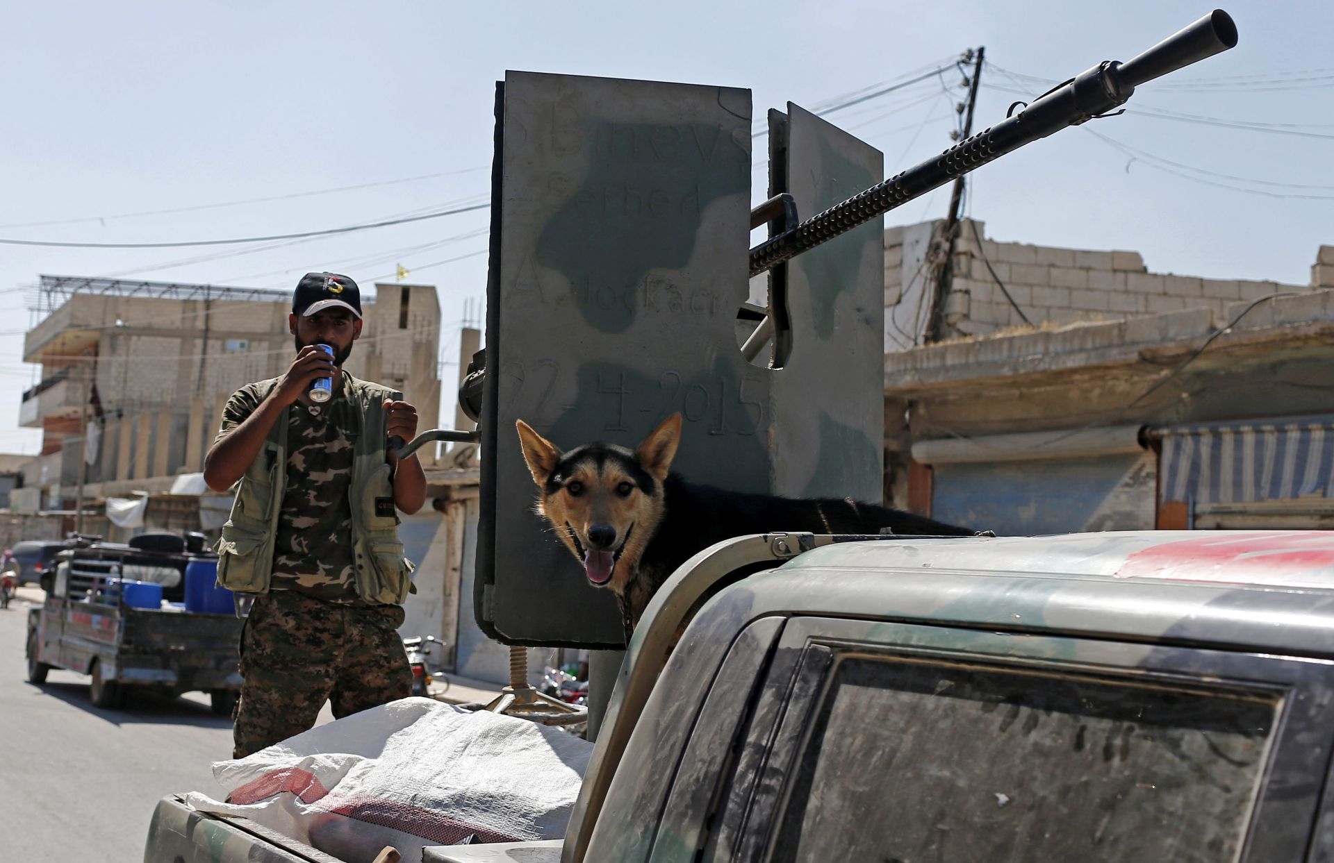epa05620113 (FILE) A file photograph dated 23 June 2015 showing a member of Kurdish People Defence Units (YPG) standing  near a machine gun with his dog after coming from the Syrian town of al-Raqqa, in Tel Abyad, Syria. Reports state the Syrian Democratic Forces (SDF) announced on 06 November 2016 that it had started a military campaign to liberate the northern Syrian city of Raqqa, the main stronghold of the Islamic State militant group in Syria. SDF is an umbrella group gathering Kurdish and Arab rebels fighting in Syria.  EPA/SEDAT SUNA