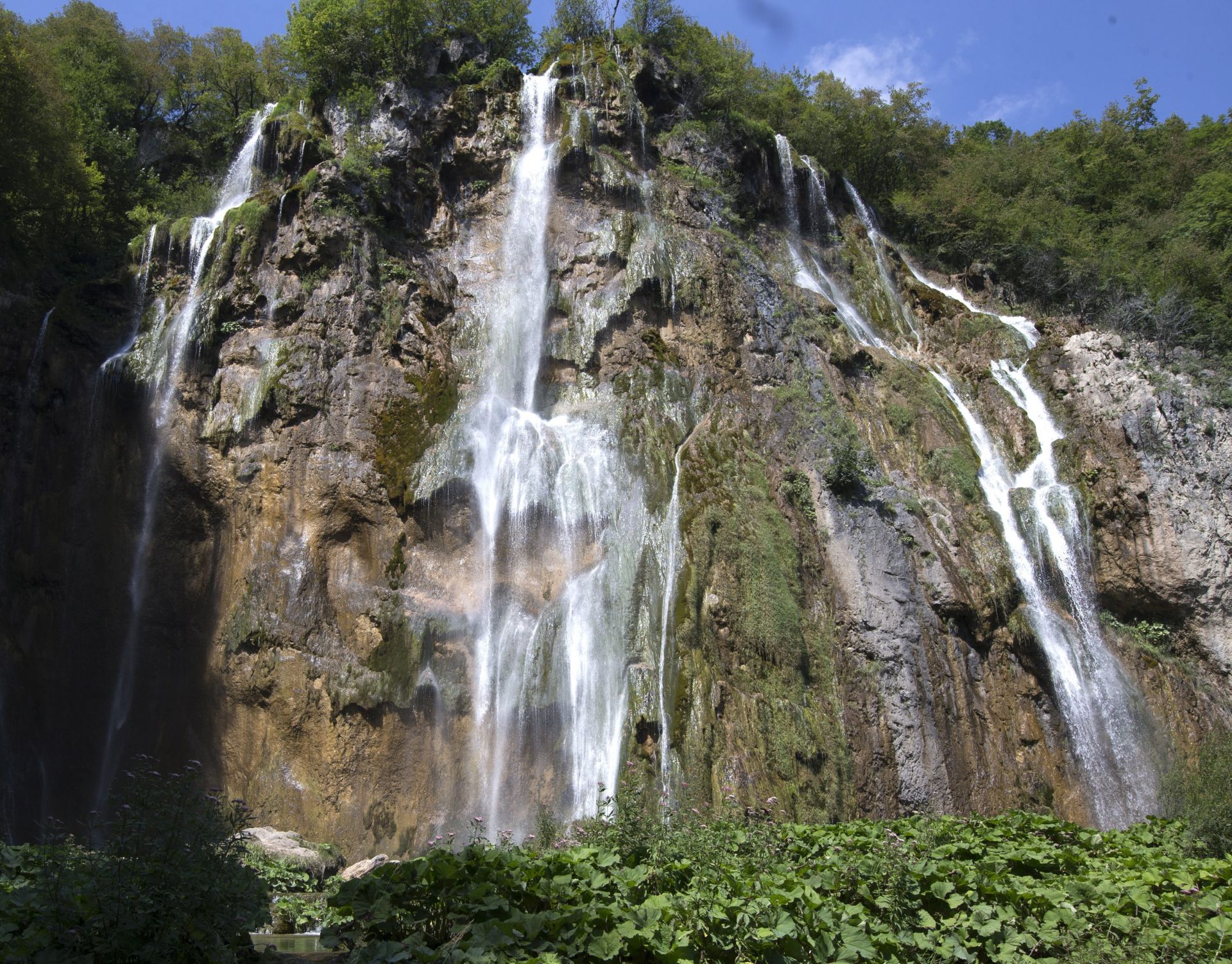 epa05468112 Waterfalls at Plitvice Lakes the National Park, Croatia, 09 August 2016. The Plitvice lakes National Pak is under protection of the UNESCO since 1979. More than 1.3 millions  tourists visit park every year. Most beautiful sites in Croatia may be put by the UNESCO in it's list of endangered parks. The main reasons are concerns about excessive construction for touristic use and too many tourists in the park yearly.  EPA/ANTONIO BAT