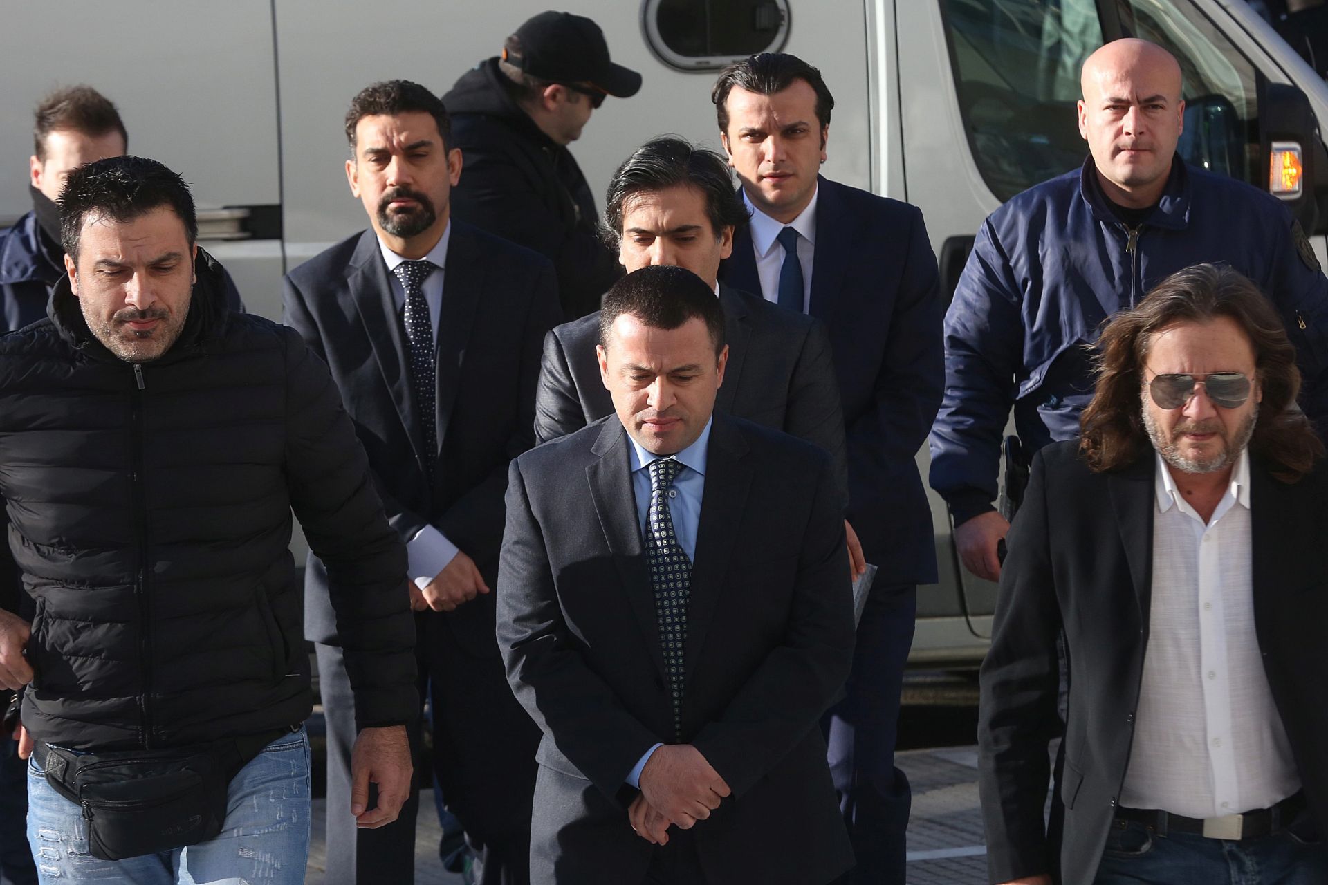 epa05714270 Four Turkish military officers (C), accused by the Turkish Government of participating in the country's foiled coup attempt last July, are escorted by Greek Police officers to the Supreme Court in Athens on 13 January 2017. Supreme Court prosecutor recommended the rejection of Turkey's extradition request for the other four Turkish officers the previous daysarguing the case is legally inadmissible, as the evidence provided by the neighbouring country's authorities were 'vague'.  EPA/ORESTIS PANAGIOTOU