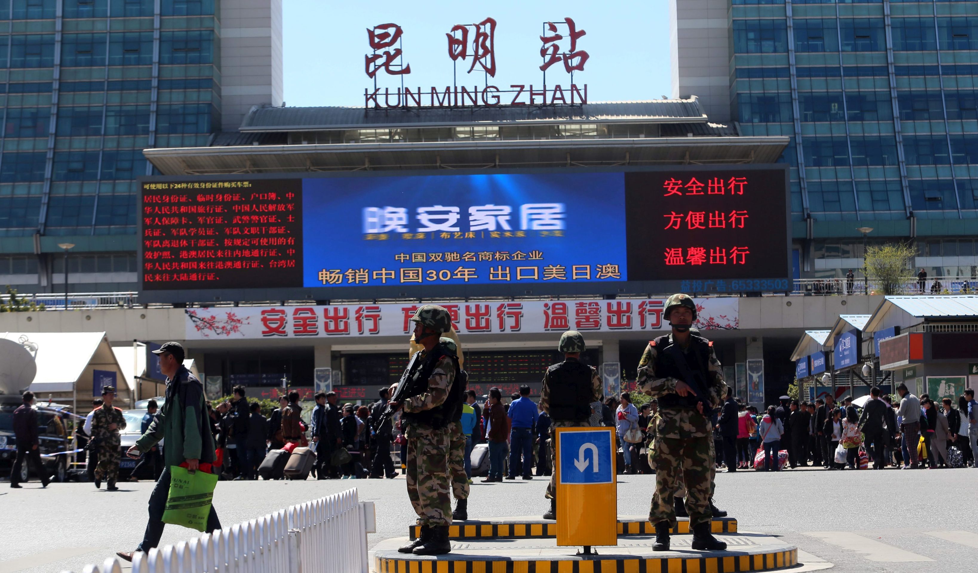 epa04105721 Paramilitary policemen guard around the railway station after a deadly attack by a group of knife-wielding men in Kunming, in southwest China's Yunnan province, 02 March 2014. At least 29 were stabbed to death, 130 wounded and four suspects shot dead in an attack at the Kunming train station, news reports said 02 March. Conflicting reports claim the death toll rose to 33 killed victims. An official investigation found that the more than 10 attackers were separatist Uighurs, Xinhua reported on Sunday, referring to the mainly Muslim ethnic group who make up about 8 million of north-west China's Xinjiang Uighur Autonomous Region's 21.8 million people.  EPA/YU LI CHINA OUT