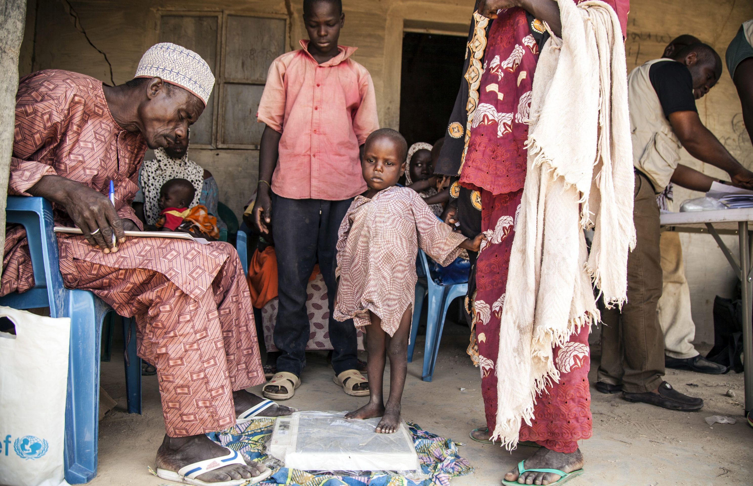 epa05666544 A handout picture provided by the United Nations Children's Fund (UNICEF) on 08 December 2016 shows a local government health worker (L) examining an infant during a regular nutrition screening in Dikwa, Borno State, northeast Nigeria, 02 November 2016. Boko Haram captured Dikwa in 2014 and the Nigerian army liberated it in February 2016. UNICEF, in partnership with the Nigerian government, was one of the first humanitarian organisations to access the town and continues to run health programmes throughout the community. There are approximately 3.8 million children in need of humanitarian support in north-east Nigeria.  EPA/UNICEF / MARK NAFTALIN / HANDOUT  HANDOUT EDITORIAL USE ONLY/NO SALES