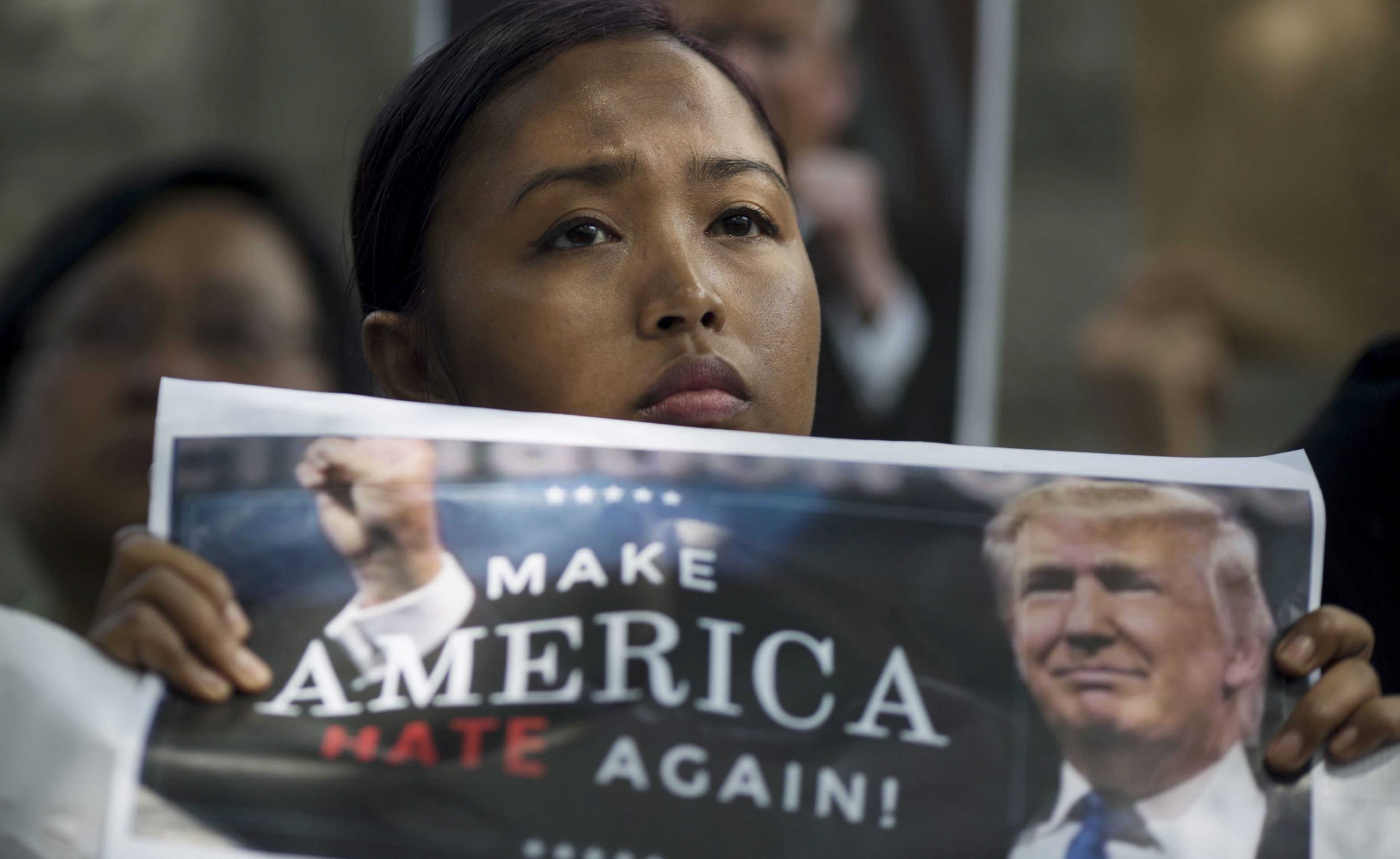 epa05763986 Eni Lestari, chairperson of the International Migrants Alliance, protests US President Donald J. Trump's so-called 'Muslim Ban'  outside the US Consulate General in Hong Kong, China, 01 February 2017. The protesters statements and sentiment echoed the global outcry pertaining to the ban, and urged Trump to drop the policy, which bars entry into the USA of nationals from seven Muslim majority countries for a period of 90 days.  EPA/JEROME FAVRE