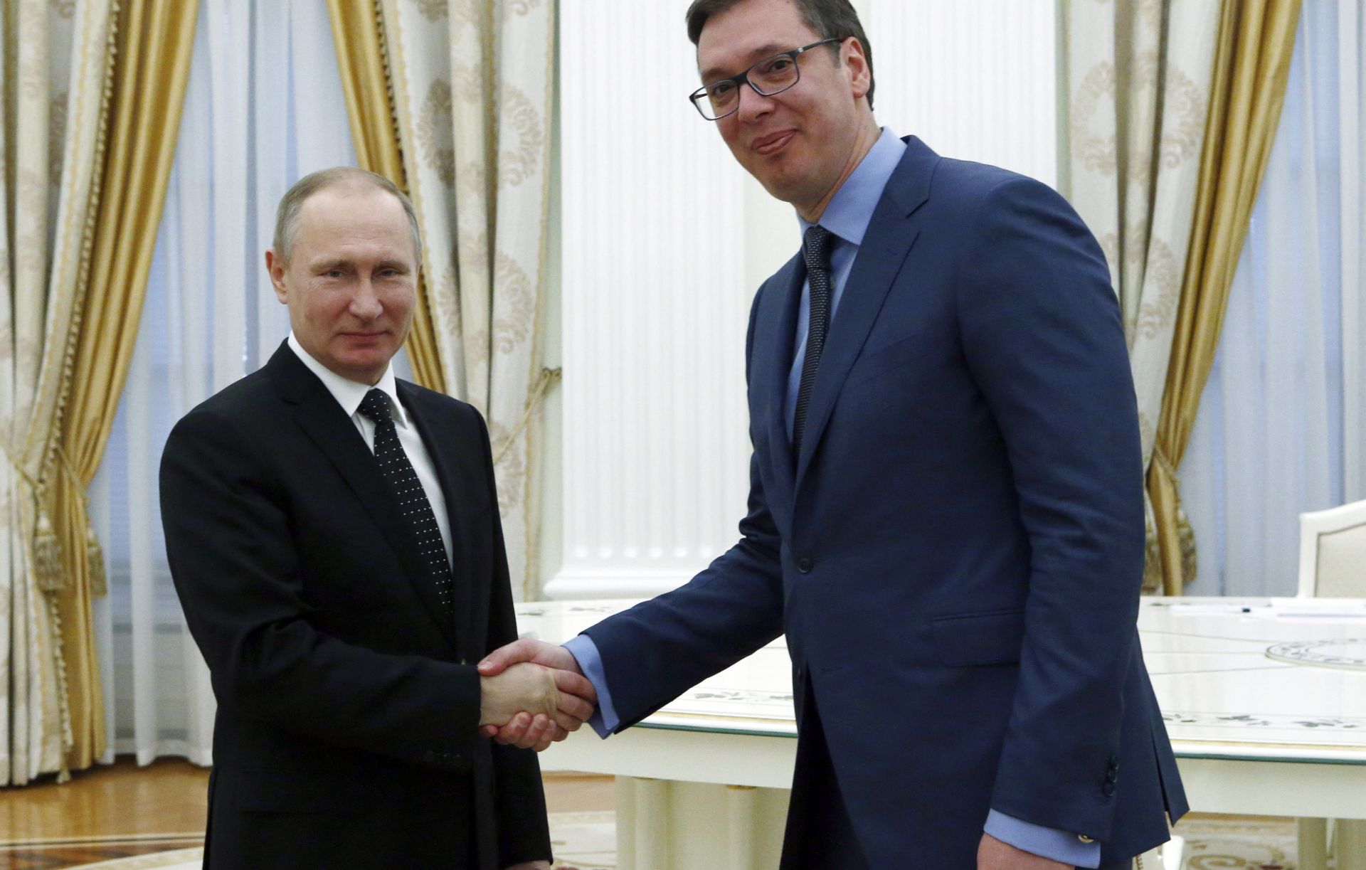 epa05873565 Serbian Prime Minister and Serbian Progressive Party candidate for the Serbian presidency, Aleksandar Vucic (R) shakes hands with Russian President Vladimir Putin (L) during their meeting at the Kremlin in Moscow, Russia, 27 March 2017.  EPA/SERGEI KARPUKHIN  / POOL