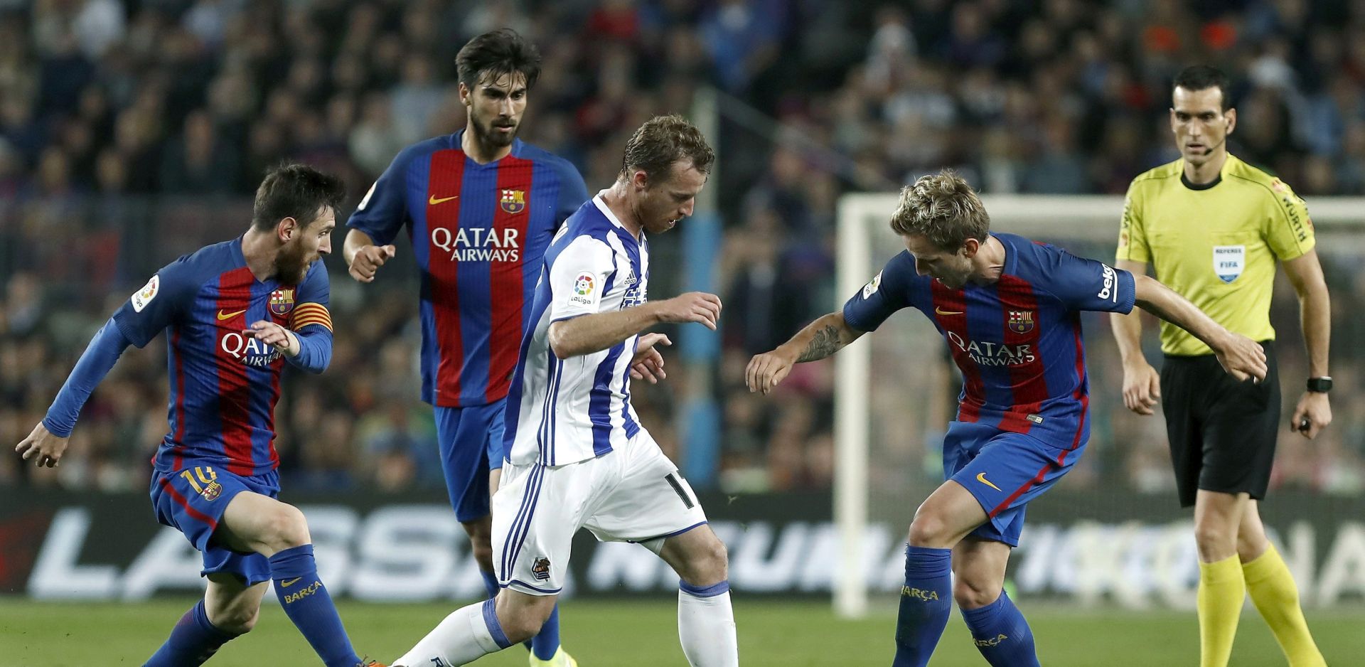 epa05909956 Real Sociedad's midfielder David Zurutuza (2-R) disputes the ball between Ivan Rakitic (R) and Leo Messi (L), both of FC Barcelona, during their Spanish Primera Division soccer match played at the Camp Nou stadium in Barcelona, Spain, on 15 April 2017.  EPA/ANDREU DALMAU