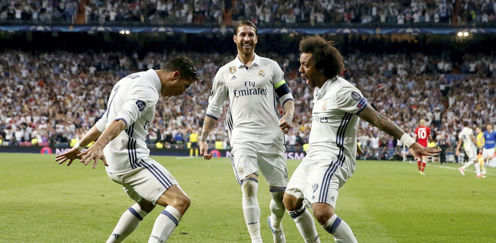 epa05914458 Real Madrid's Portuguese forward Cristiano Ronaldo (L), Spanish defender Sergio Ramos (C) and Brazilian defender Marcelo Vieira da Silva celebrate the 3-2 score against Bayern Munich during a UEFA Champions League quarter final second leg match at the Santiago Bernabeu stadium in Madrid, Spain, late 18 April 2017.  EPA/JUANJO MARTIN