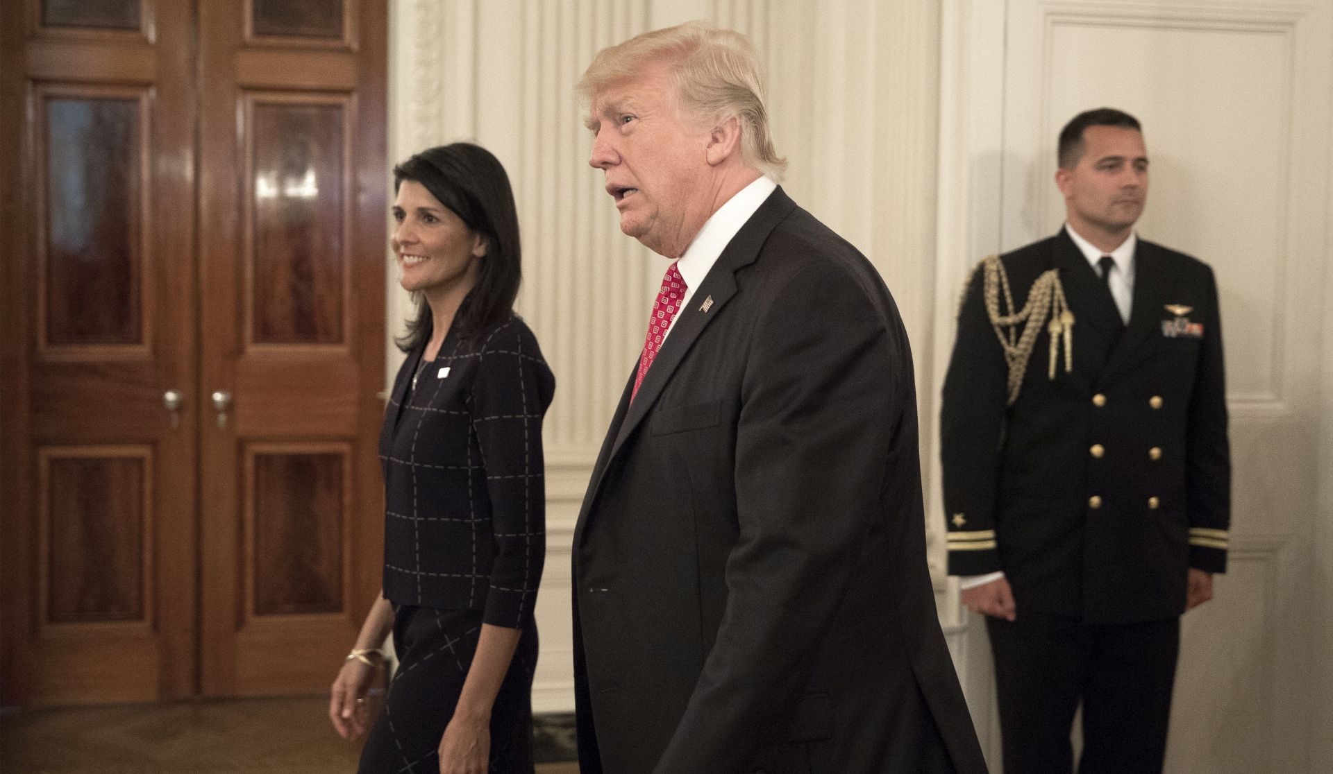 epa05925583 US President Donald J. Trump (R) and US Ambassador to the UN Nikki Haley (L) enter the State Dining Room to attend a working lunch with ambassadors of countries on the United Nations Security Council, at the White House in Washington, DC, USA, 24 April 2017.  EPA/MICHAEL REYNOLDS