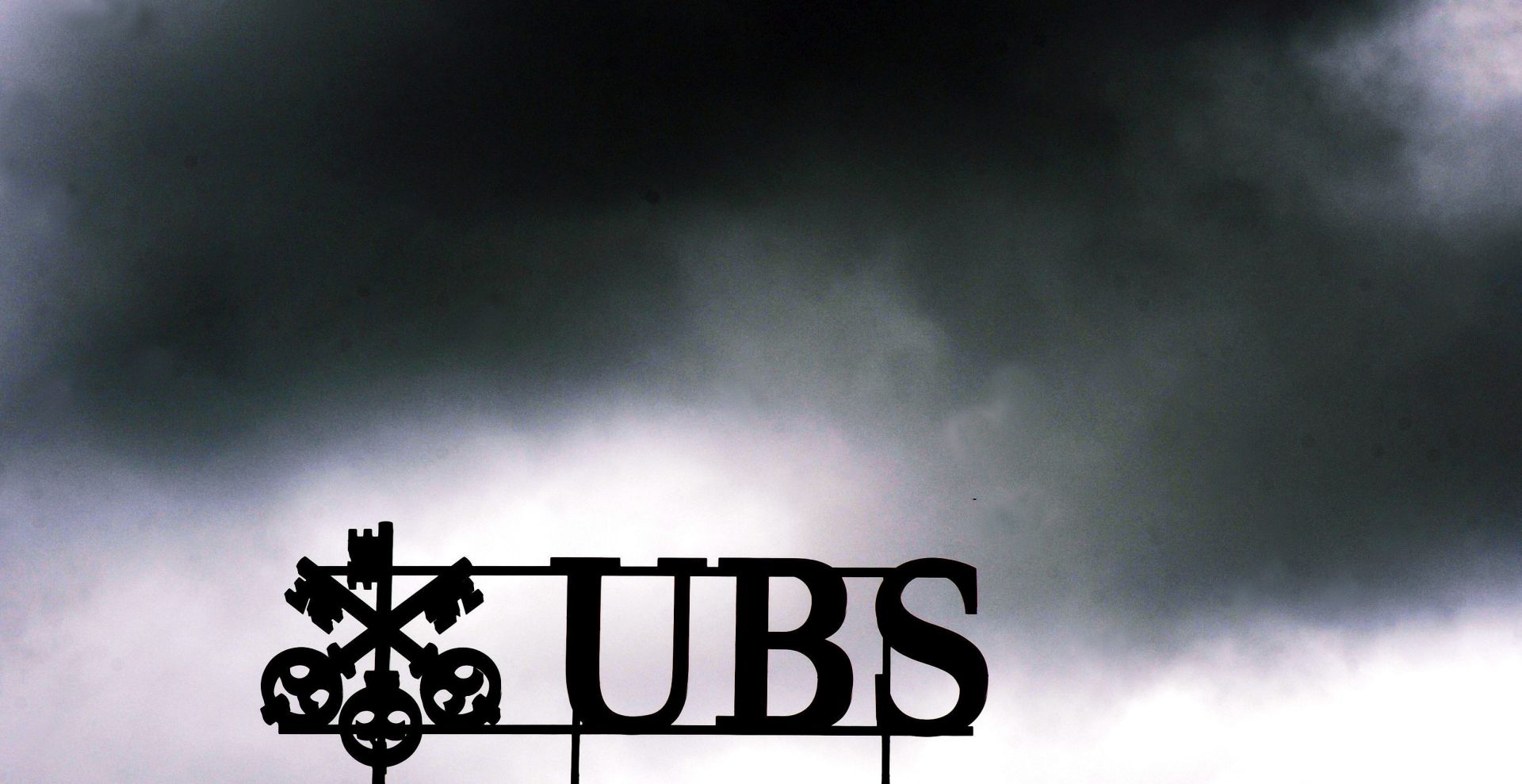epa04334764 (FILE) A file photograph dated 14 July 2011 shows dark clouds above the UBS logo on the bank's head office in Zurich, Switzerland. UBS has settled a major tax evasion case in Germany and has agreed to pay a penalty of 300 million euros (403 million dollars), Switzerland's biggest bank said 29 July 2014 in Zurich.
Prosecutors in Bochum in the German state of North Rhine-Westphalia had launched investigations against UBS on suspicion that it had helped German clients hide taxable income in foundations in about 750 cases. 'Tax evasion does not have a future as a business model,' North Rhine-Westphalia's Justice Minister Thomas Kutschaty said. Provisions for the penalty put a burden on earnings in the second quarter. Operating profits at the bank's wealth management arm dropped 43 per cent to 355 million Swiss francs (392 million dollars), compared to the same period last year.  EPA/WALTER BIERI *** Local Caption *** 50577060