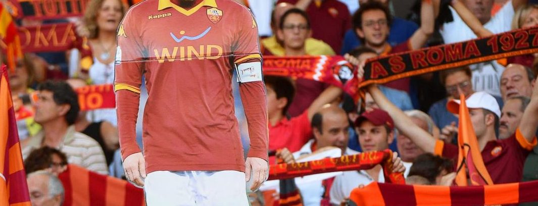 epa05942201 (FILE) Roma supporters hold a cardboard cutout of Francesco Totti during the Italian Serie A soccer match between AS Roma and Hellas Verona at Olimpico stadium in Rome, Italy, 27 September 2014 (reissued 03 May 2017). Italian Serie A side AS Roma confirmed on 03 May 2017 that Roma legend Francesco Totti will retire at the end of the season. The 40-year-old scored 250 goals in 616 appearances for the Giallorossi since 1993 and won the FIFA World Cup in 2006.  EPA/MAURIZIO BRAMBATTI