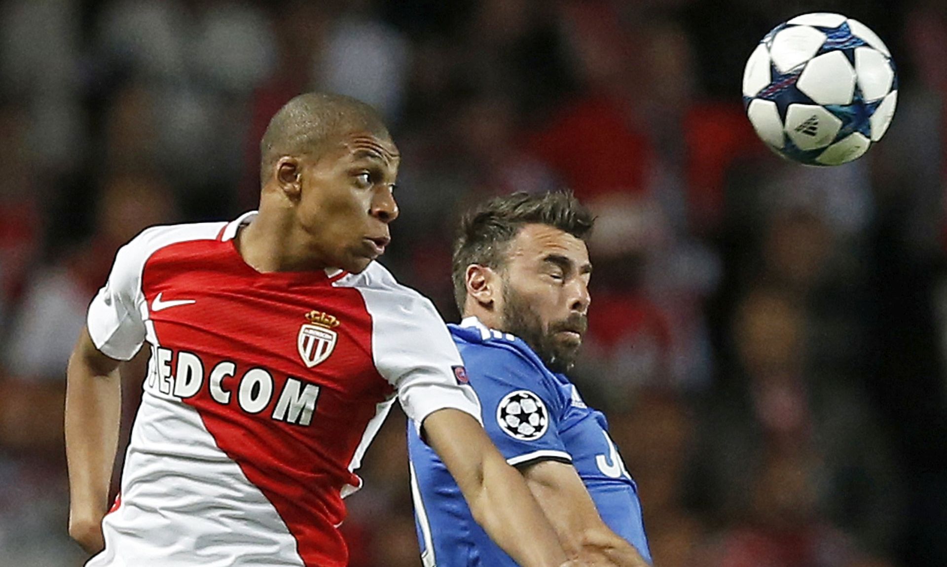 epa05942506 Kylian Mbappe (L) of AS Monaco and Andrea Barzagli (R) of Juventus FC rise for a header during the UEFA Champions League semi final, first leg soccer match between AS Monaco and Juventus at Stade Louis II in Monaco, 03 May 2017.  EPA/GUILLAUME HORCAJUELO