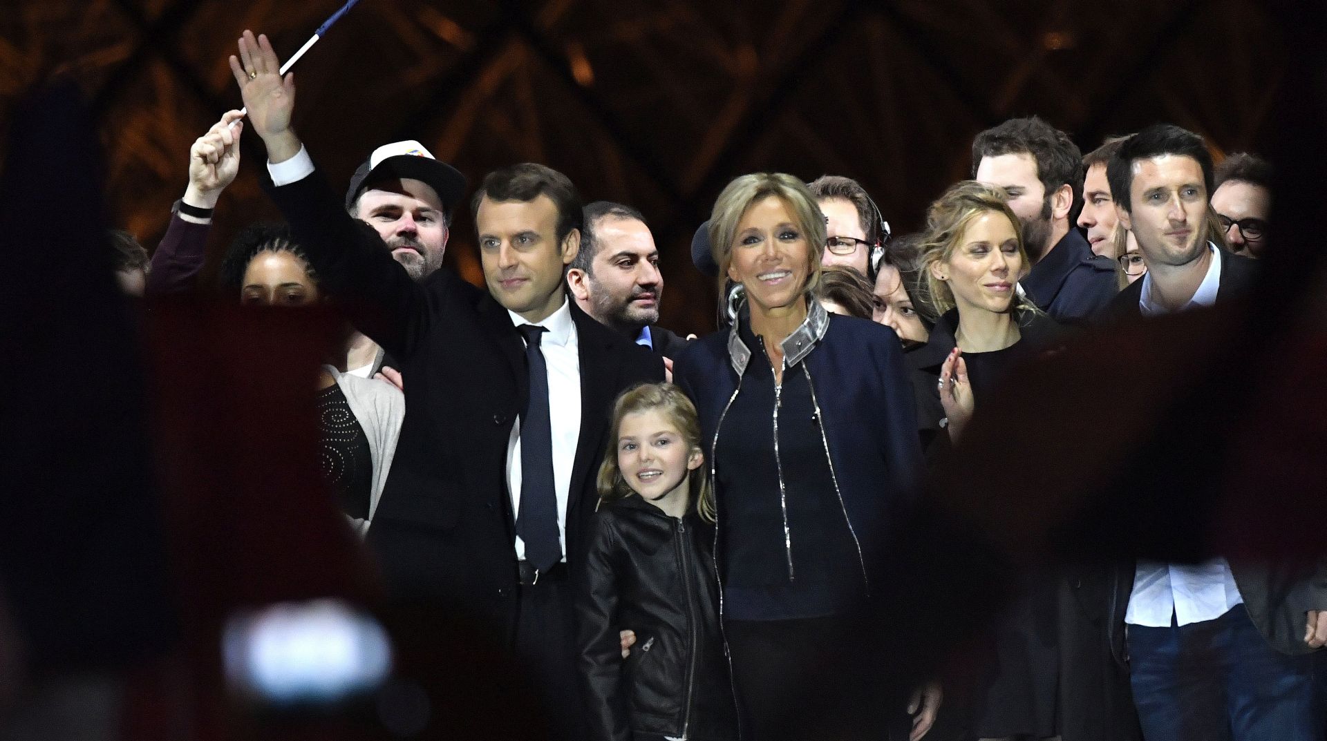 epa05949550 French presidential election candidate for the 'En Marche!' (Onwards!) political movement, Emmanuel Macron (L) and his wife Brigitte Trogneux (R) celebrate on stage after winning the second round of the French presidential elections at the Carrousel du Louvre in Paris, France, 07 May 2017. Emmanuel Macron defeated Marine Le  Pen in the final round of France's presidential election, with exit polls indicating that Macron is leading with approximately 65.5 per cent of the vote.  EPA/CHRISTOPHE PETIT TESSON