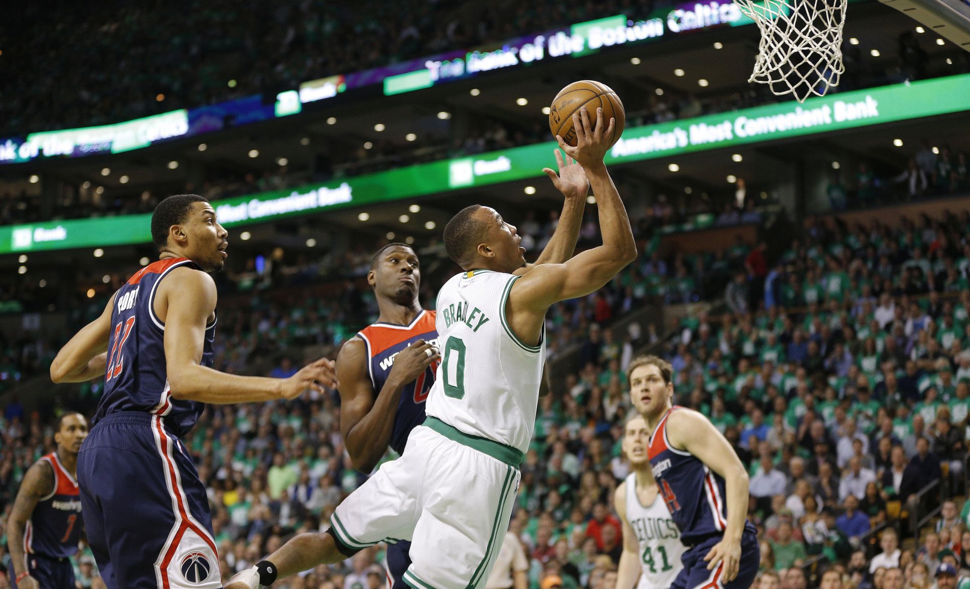 epa05956090 Boston Celtics guard Avery Bradley (R) drives past Washington Wizards Otto Porter Jr. (L) and Ian Mahinmi (C) during the first quarter of their NBA Eastern Conference Semifinal game five at the TD Garden in Boston, Massachusetts, USA 10 May 2017. The best-of-seven series is tied 2-2.  EPA/CJ GUNTHER