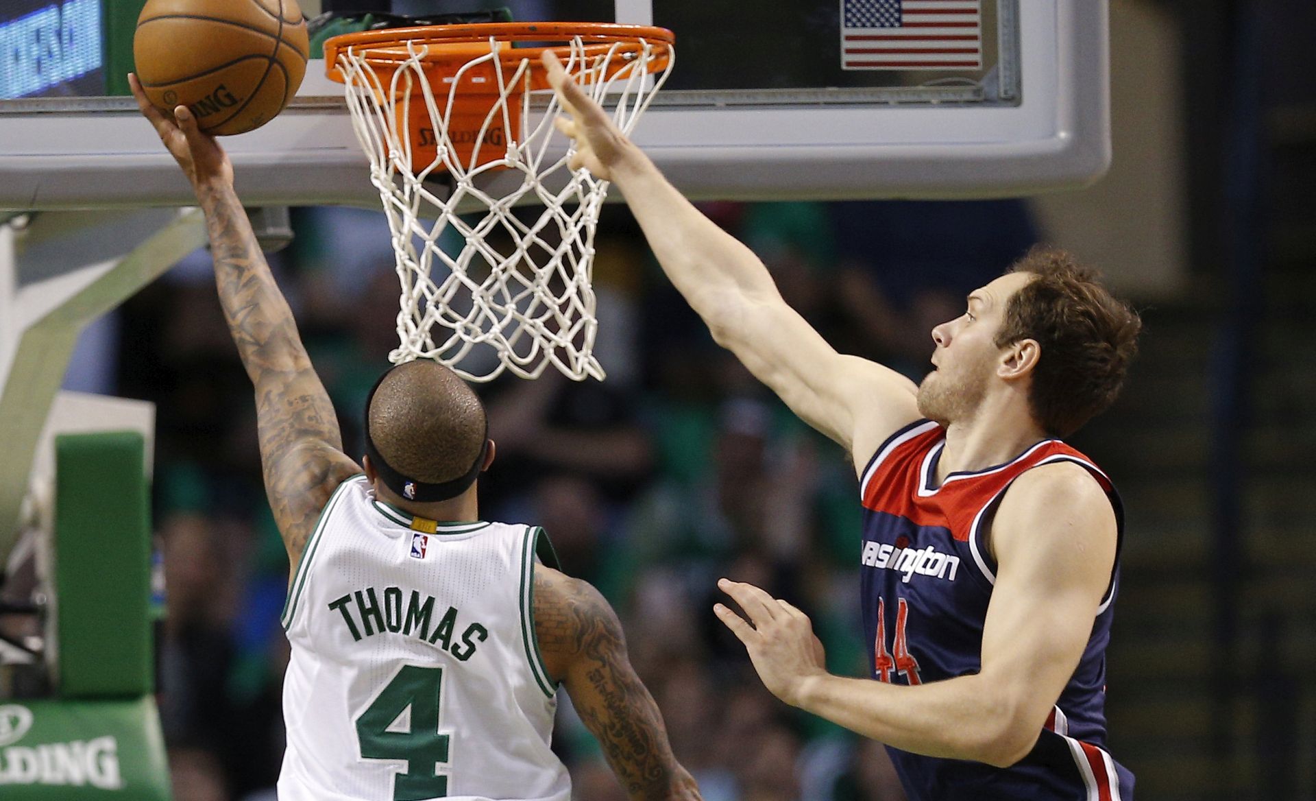 epa05956126 Boston Celtics guard Isaiah Thomas (L) makes a shot past the defending Washington Wizards guard Bojan Bogdanovic of Croatia (R) during the second half of their NBA Eastern Conference Semifinal game at the TD Garden in Boston, Massachusetts, USA, 10 May 2017. The Boston Celtics lead the best of seven series 3-2.  EPA/CJ GUNTHER