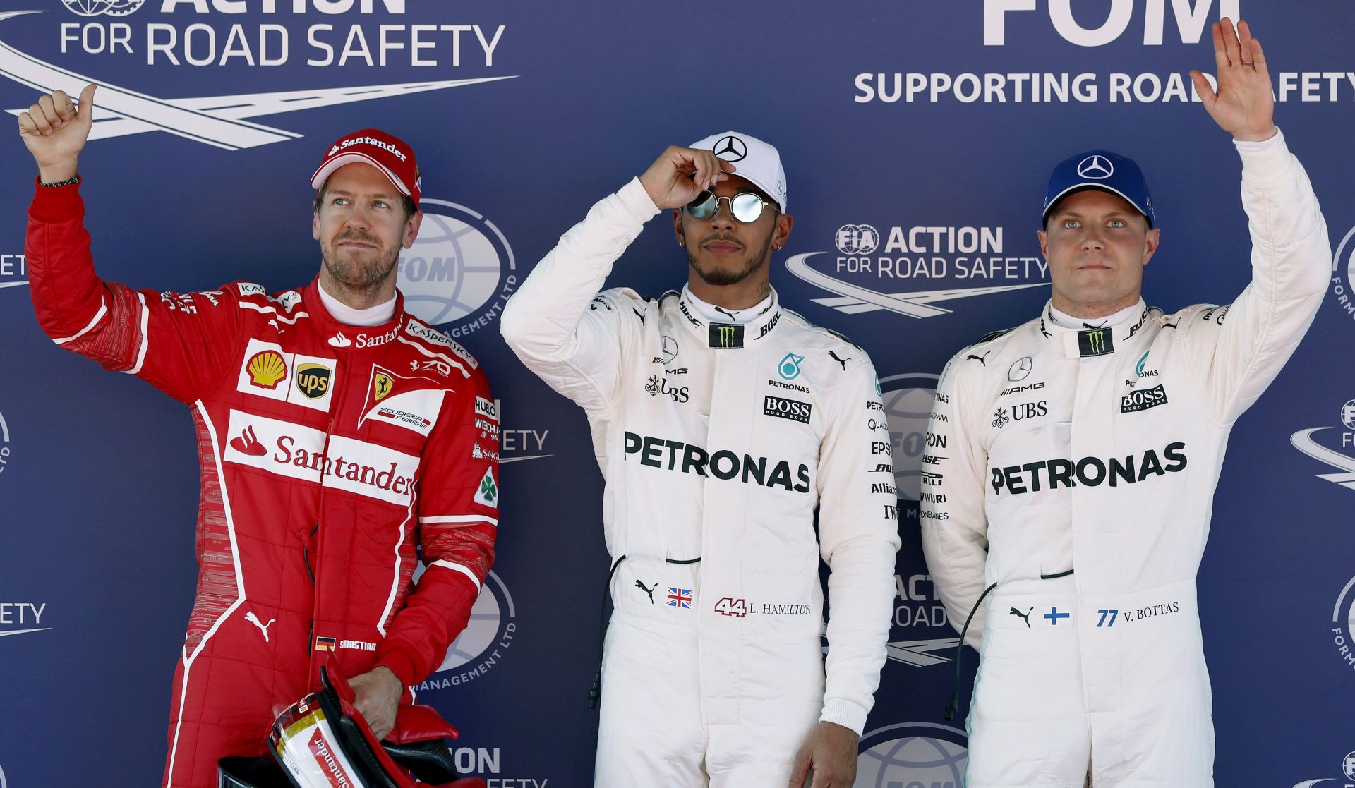 epa05961354 British Formula One driver Lewis Hamilton (C) from Mercedes AMG, German Sebastian Vettel (L) and Finnish Valtteri Bottas (R) celebrate their pole position, second and thrid best time, respectively, after the qualifying session held at the Circuit de Barcelona-Catalunya in Montmelo, near Barcelona, northeastern Spain, 13 May 2017. The 2017 Formula One Grand Prix of Spain will take place on 14 May 2017.  EPA/ANDREU DALMAU