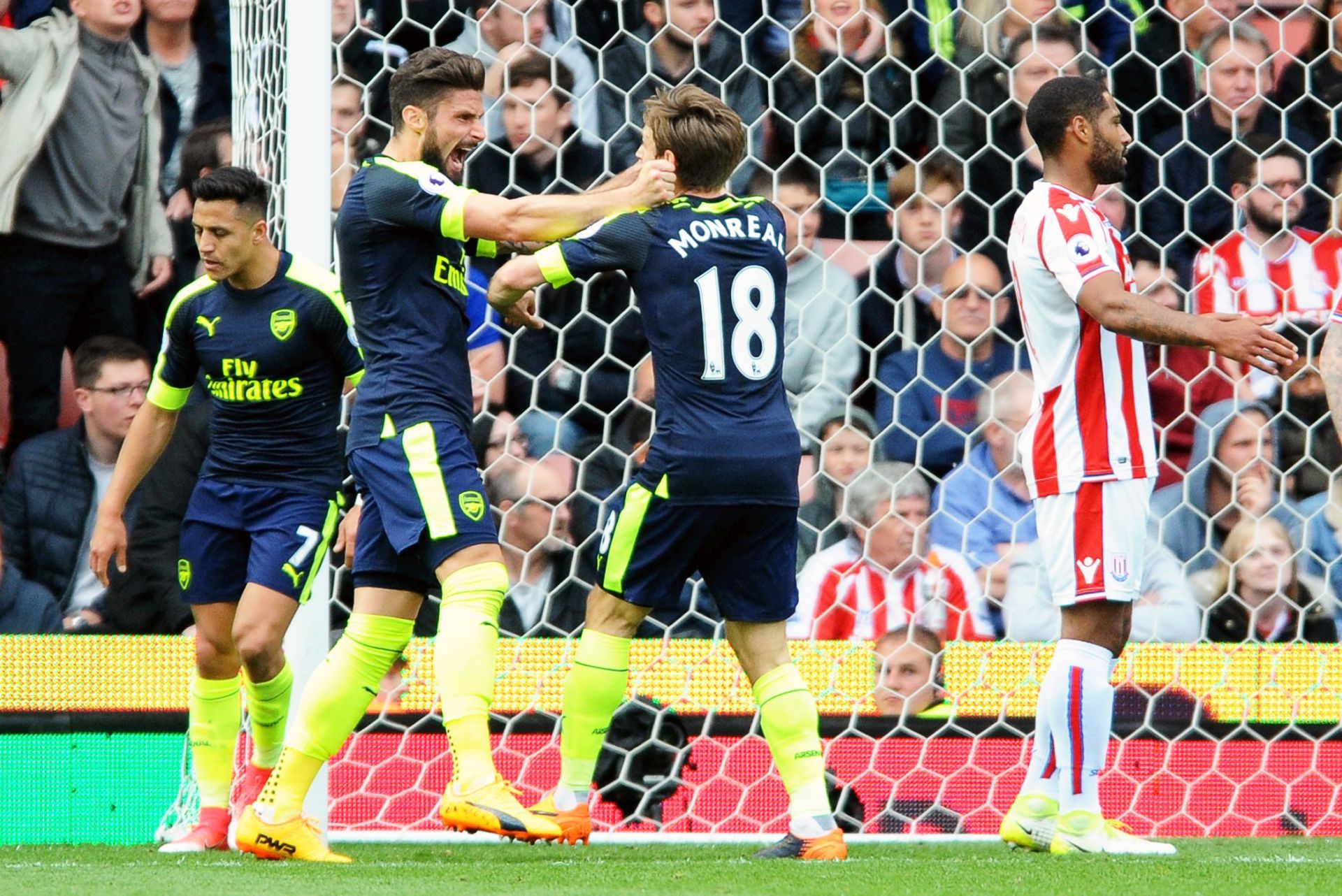 epa05961852 Arsenal's Olivier Giroud (2-L) celebrates with his teammate Nacho Monreal (C) after scoring the 1-0 lead during the English Premier League soccer match between Stoke City and Arsenal FC in Stoke on Trent, Britain, 13 May 2017.  EPA/RUI VIEIRA EDITORIAL USE ONLY. No use with unauthorized audio, video, data, fixture lists, club/league logos or 'live' services. Online in-match use limited to 75 images, no video emulation. No use in betting, games or single club/league/player publications.