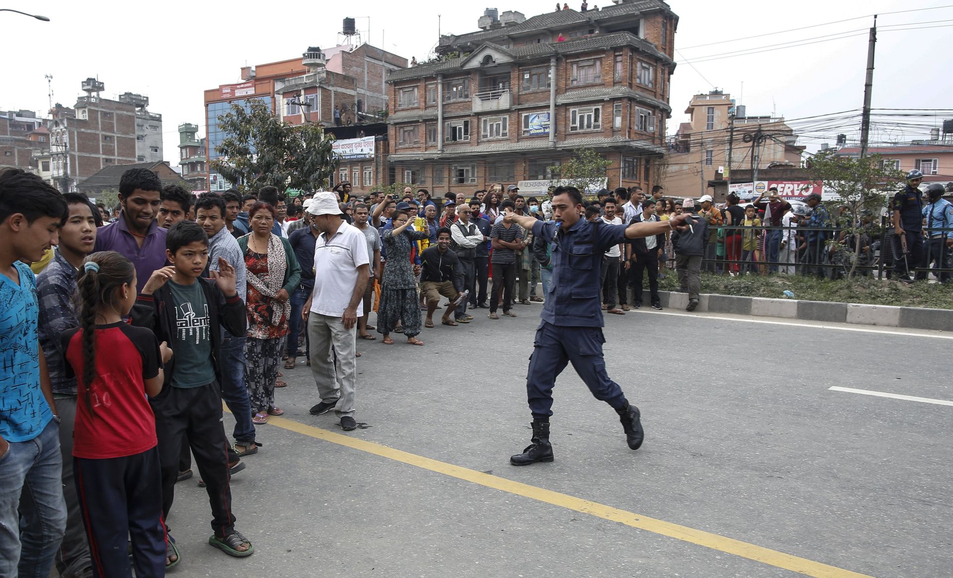 epa05962852 A police officers manages a crowd as a Nepalese army bomb disposal squad works to defuse a suspected bomb during a local election in Bhaktapur, Nepal, 14 May 2017. Nepalese people lined to cast their votes in various polling stations for local level general elections held for the first in 20 years.  EPA/NARENDRA SHRESTHA