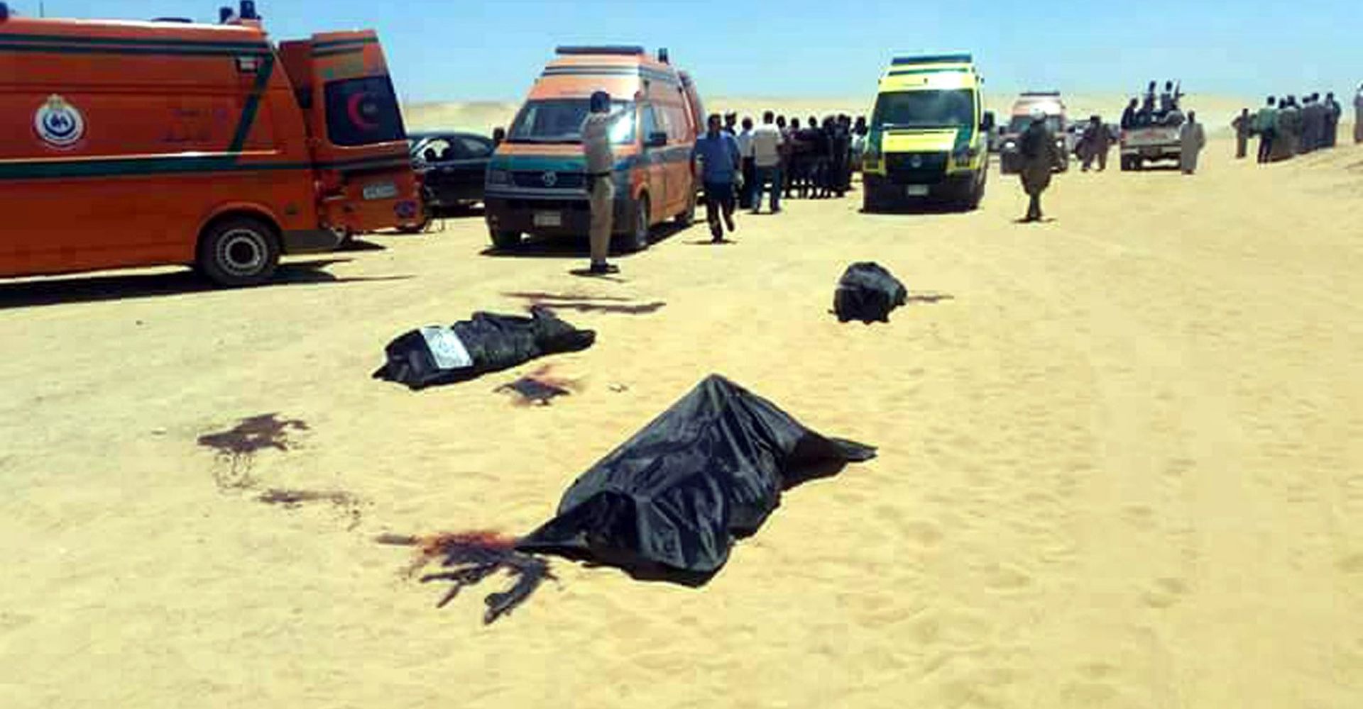 epa05991661 Security officials and emergency services at the site of an armed attack on a bus near the Monastery of St Samuel the Confessor, in Minya Province, central Egypt, 26 May 2017. According to news reports, a group of Coptic Christians were attacked in their bus en route to the Monastery when gunmen opened fire on them, killing at least 20 and injuring dozens.  EPA/STR EGYPT OUT BEST QUALITY AVAILABLE