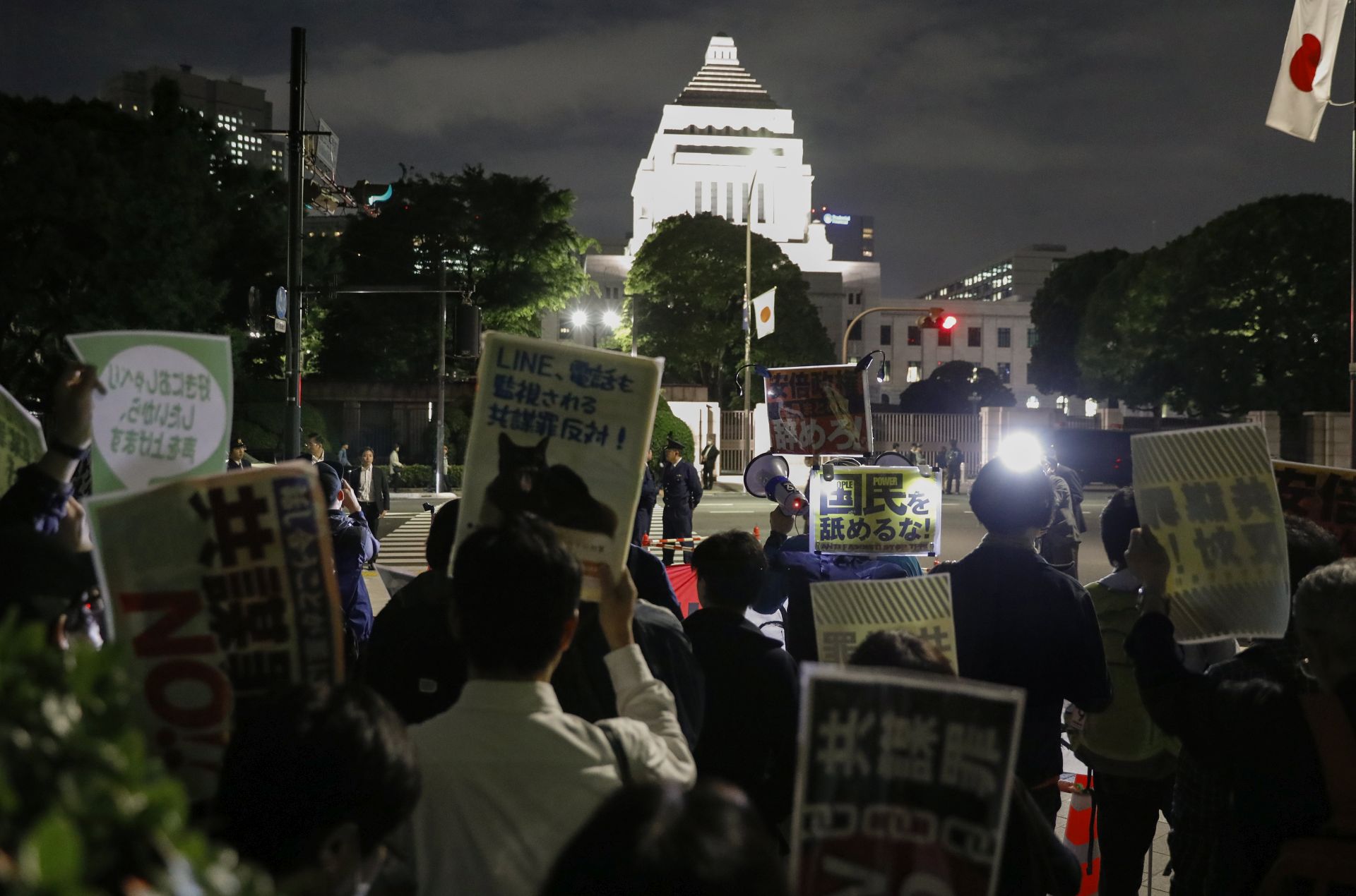 epa05969673 Demonstrators shouting slogans raise their placards reading 'No Conspiracy!' as they protest against the controversial 'conspiracy bill' outside Japan's parliament in Tokyo, Japan, 17 May 2017. Abe's ruling coalition is planning to pass the new legislation through the Lower House despite critics that say it could be a threat on civil rights. The Placard reads 'Stop railroad bills'.  EPA/KIMIMASA MAYAMA
