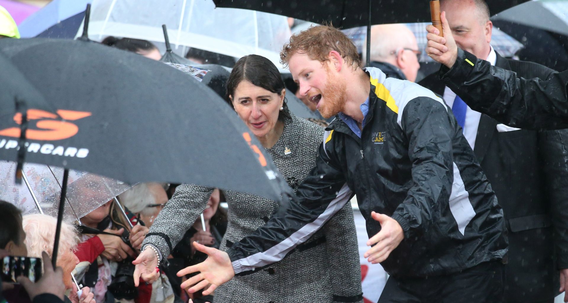 epa06014064 Britain's Prince Harry (R) reacts as he recognises 97-year-old Daphne Dunne, who he had met on an earlier visit to Sydney, during a walk around The Rocks in Sydney, Australia, 07 June 2017. Prince Harry is visiting Sydney to promote the city's 2018 Invictus Games. During the two-day visit, the prince will launch the 500-day countdown to the Invictus Games sports competition for 500 wounded former and serving defence personnel from 17 nations that will be held in the harbour city in October 2018.  EPA/DAVID MOIR AUSTRALIA AND NEW ZEALAND OUT