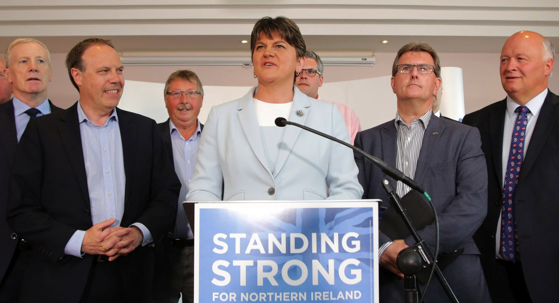 epa06019045 Northern Ireland Democratic Unionist Party (DUP) Leader Arlene Foster and party colleagues address the media at the Stormont Hotel, Belfast, Northern Ireland, 09 June 2017. The DUP returned 10 Members of Parliament to the British Parliament following the General Election on 08 June 2017. Britain's general election ended in a hung parliament with the Conservative Party unable to gain a majority.  EPA/PAUL McERLANEl