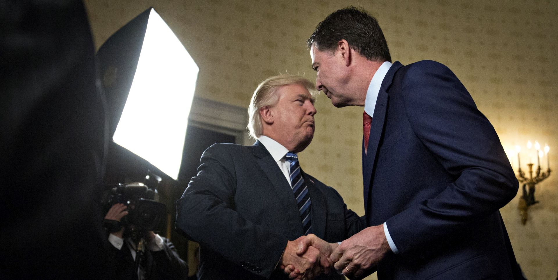 epa06032347 (FILE) - US President Donald J. Trump, left, shakes hands with James Comey, then director of the Federal Bureau of Investigation (FBI), during an Inaugural Law Enforcement Officers and First Responders Reception in the Blue Room of the White House in Washington, DC, USA, 22 January 2017. President Trump on 16 June acknowledged that his firing of Comey as FBI director is a part of an investigation that includes potential obstruction of justice.  EPA/Andrew Harrer / POOL