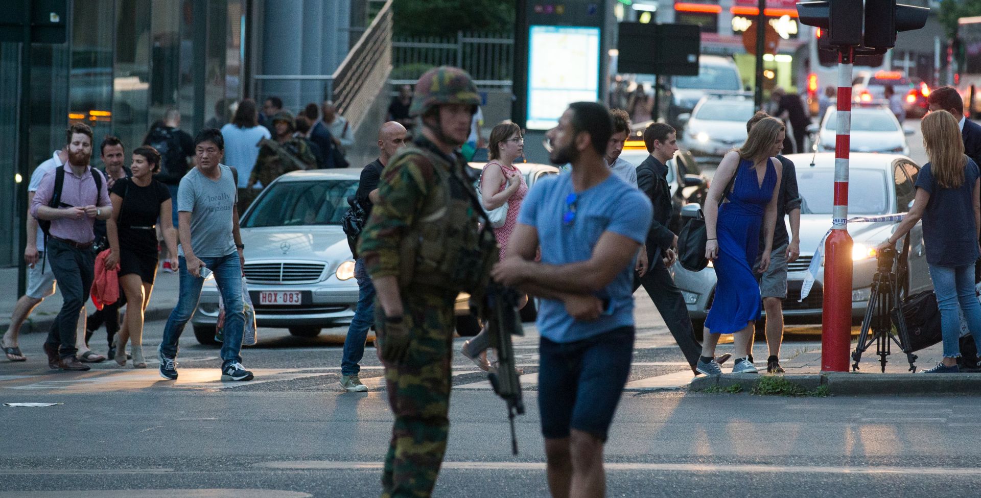 epa06039907 People walk past an armed soldier outside of the Brussels Central Station after a neutralized terrorist attack attempt, in Brussels, Belgium, 20 June 2017. According to Belgian media, police shot a suspect wearing an explosive belt at the Brussels Central Station. Belgian police also confirmed there was a small explosion in the Brussels Central Station, but said there are not much damage done and situation is under control. The cause of the explosion is unknown.  EPA/STEPHANIE LECOCQ