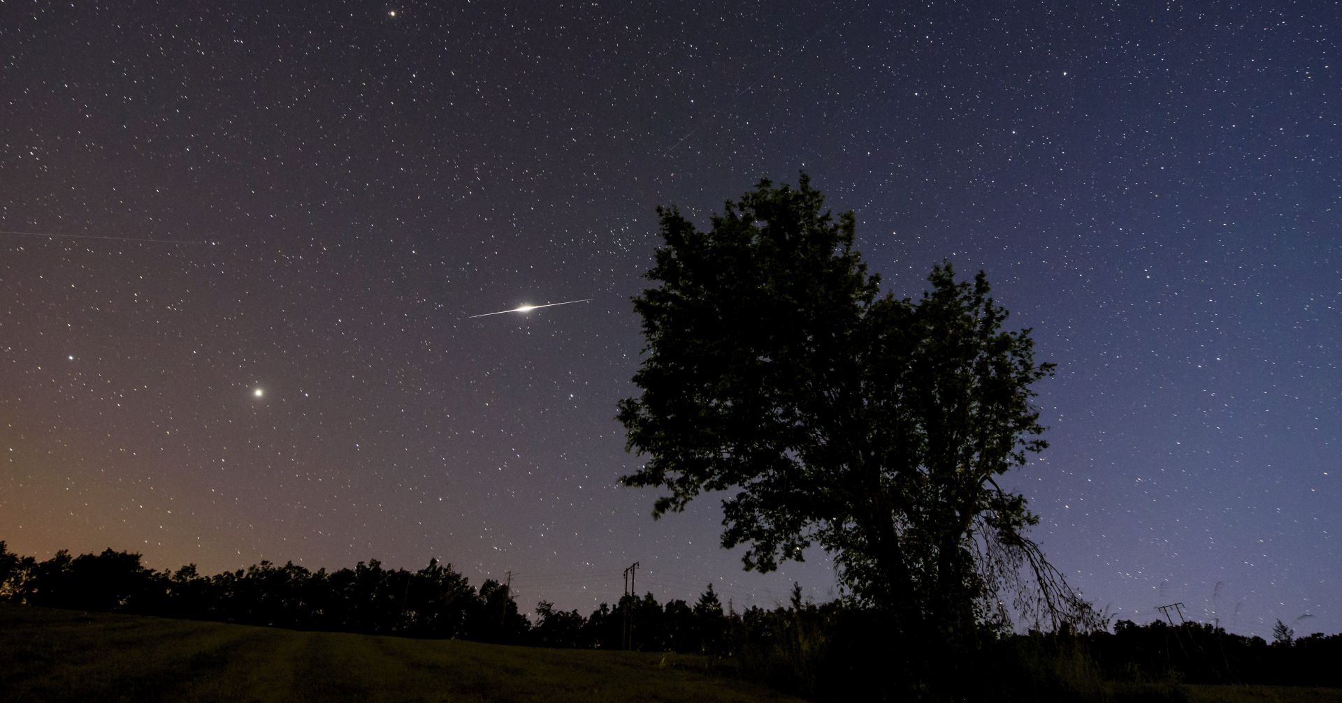 epa06030835 An iridium satellite's flash (C-L) is seen on the summer night sky from the vicinity of Repashuta, some 170km northeast of Budapest, Hungary, late 15 June 2017.  EPA/PETER KOMKA HUNGARY OUT