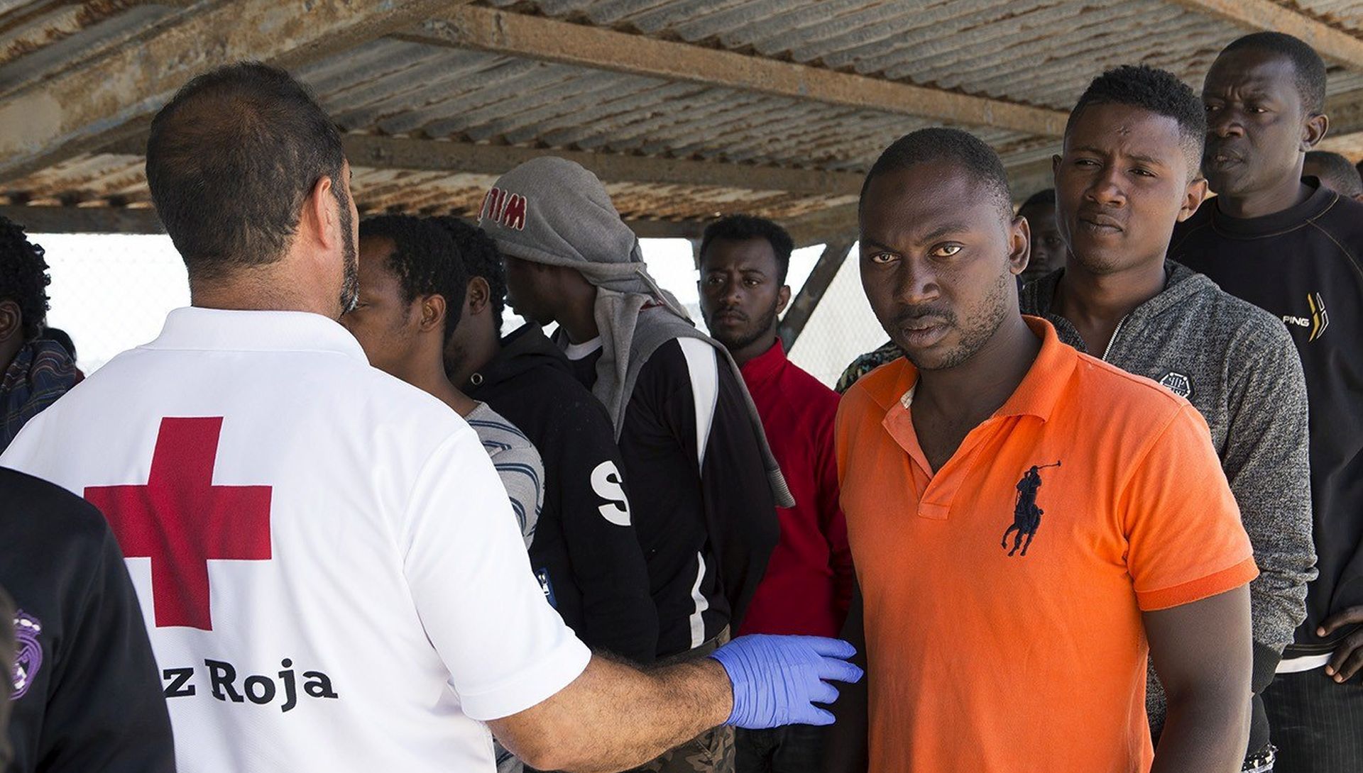 epa06047751 Red Cross workers attend to some of the 72 migrants rescued at sea off the coast of Alboran Island as they arrive in the port of Motril, Spain, 24 June 2017.  EPA/Miguel_Paquet