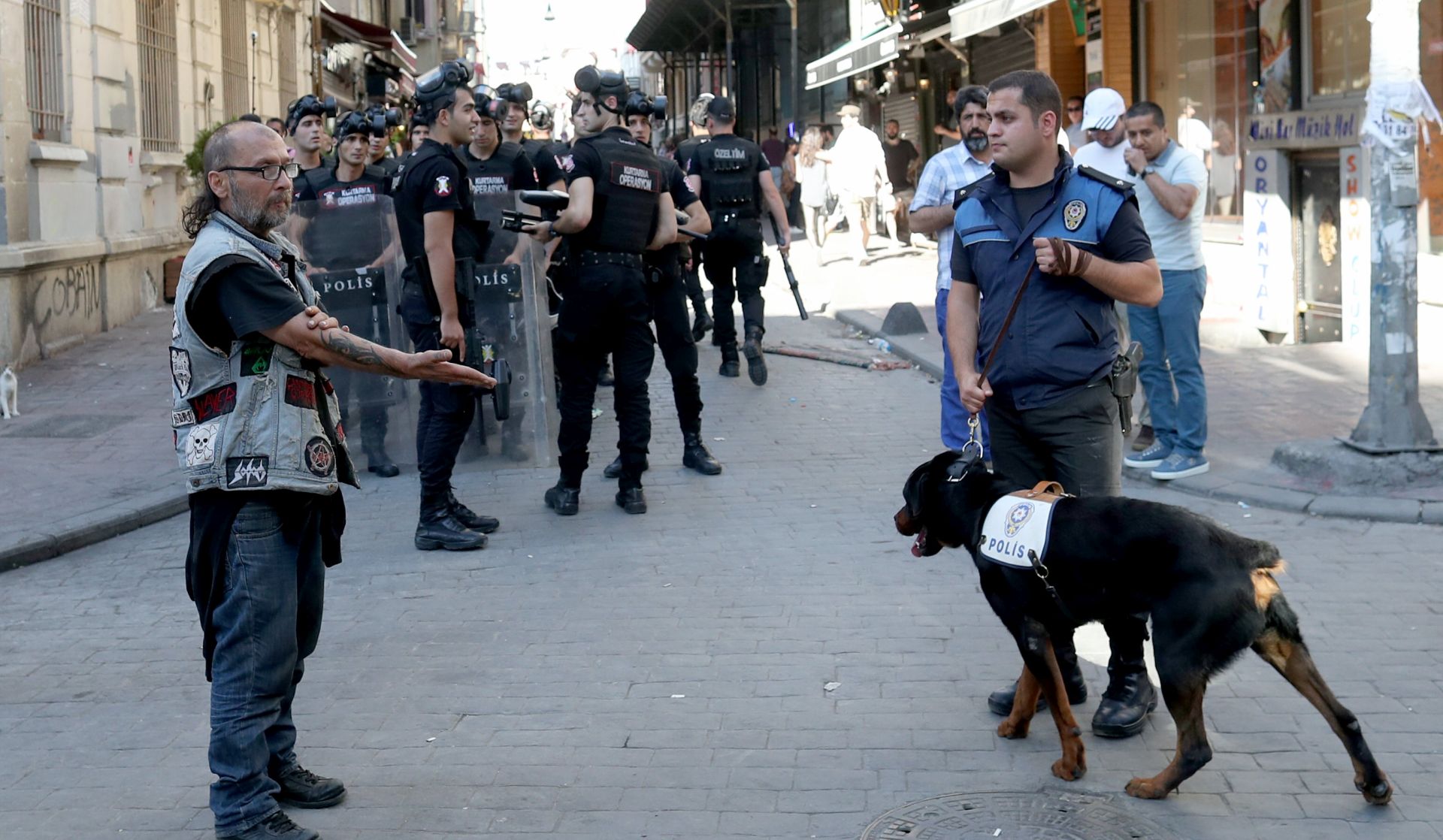 epa06049861 A Turkish policeman patrols with a dog at Taksim Square during the Istanbul LGTB Pride Parade which was cancelled due to security concerns by the governor of Istanbul, in Istanbul, Turkey, 25 June 2017. Transgenders people and supporters try to march in central Istanbul as part of the Trans Pride Week 2017, which is organized by Istanbul's 'Lesbians, Gays, Bisexuals, Transvestites and Transsexuals' (LGBT) solidarity organization.  EPA/SEDAT SUNA