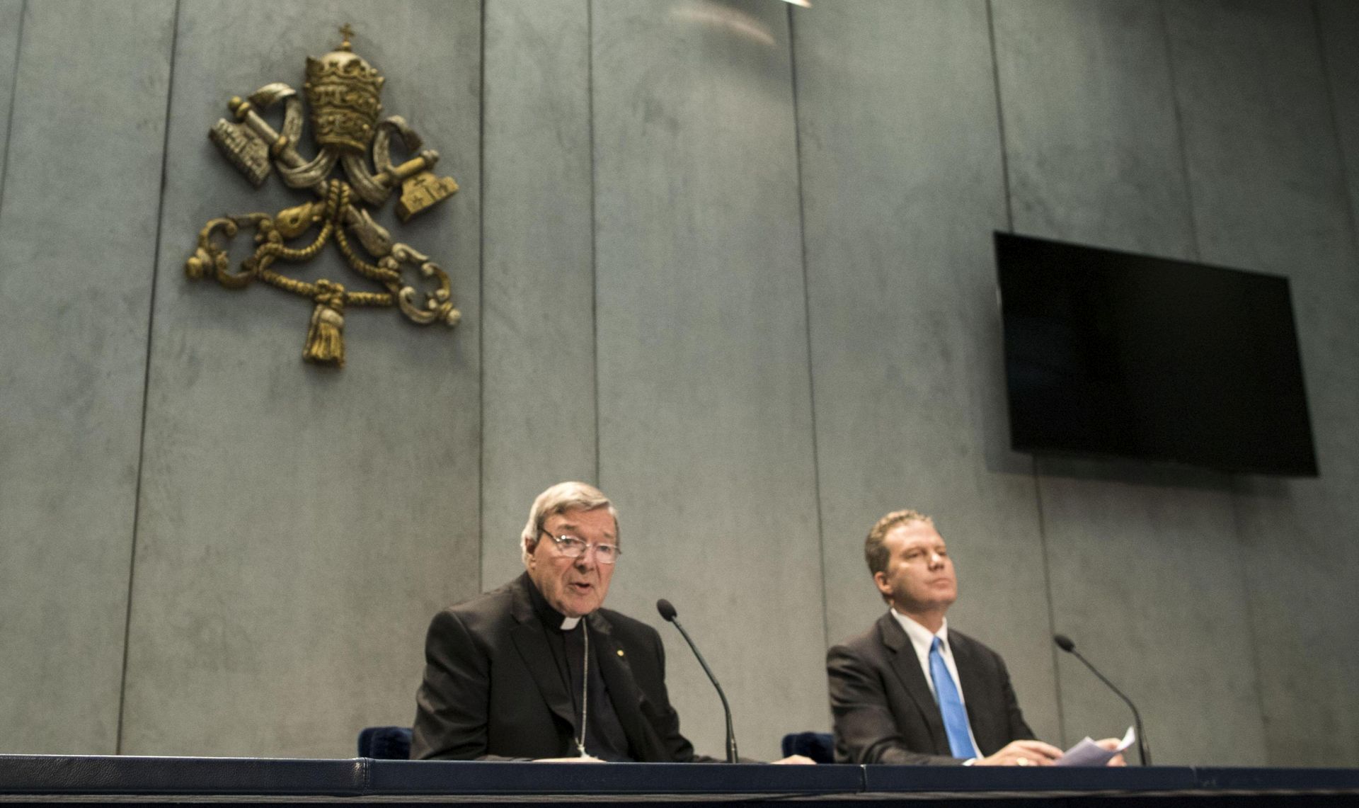 epa06055402 Cardinal George Pell (L) is flanked by Vatican spokesman Greg Burke as Pell speaks to members of the media, at the Vatican, 29 June 2017. Cardinal Pell, 76, Australia's most senior Catholic, has been charged on 29 June 2017, with multiple counts of historical sexual assault offences on summons and he is required to appear for a hearing at the Melbourne Magistrates Court on 18 July 2017, Victoria Police Deputy Commissioner Shane Patton said in a press conference. The senior cleric always denied any wrongdoing.  EPA/MASSIMO PERCOSSI