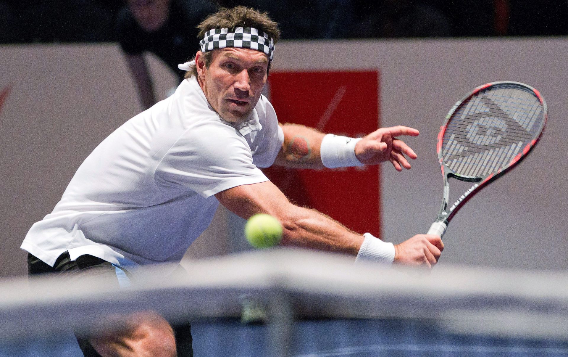 epa03143399 Australia's Pat Cash returns the ball to USA:s John McEnroe during their match in ATP Champions tour tennis tournament at Stockholm Waterfront Congress Centre in Sweden on March 13, 