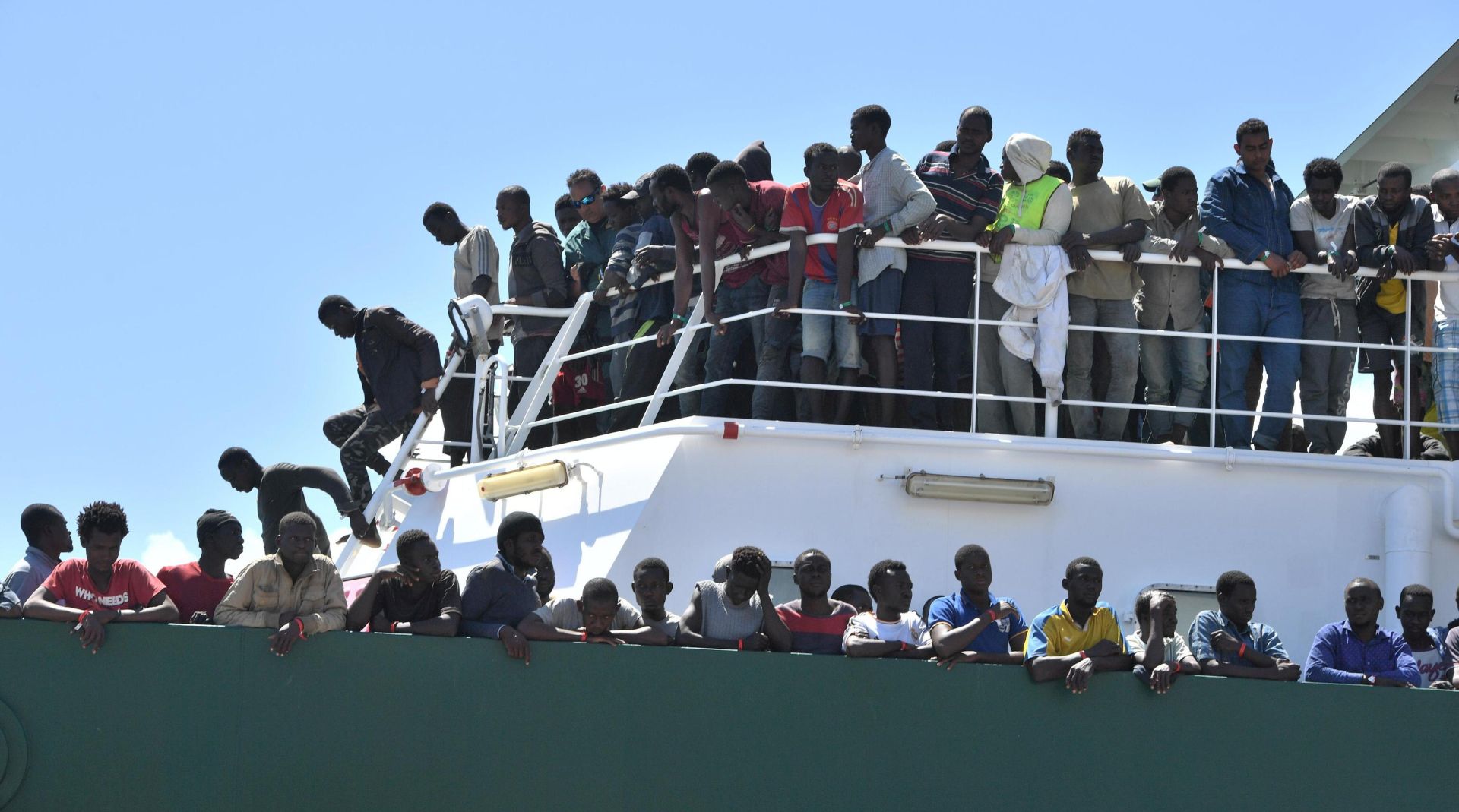 epa06055993 Migrants wait to disembark from the Spanish ship 'Rio Segura' in the harbour of Salerno, Italy, 29 June 2017. About 1216 migrants on board including children, were rescued while attempting to cross the Mediterranean.  EPA/CIRO FUSCO