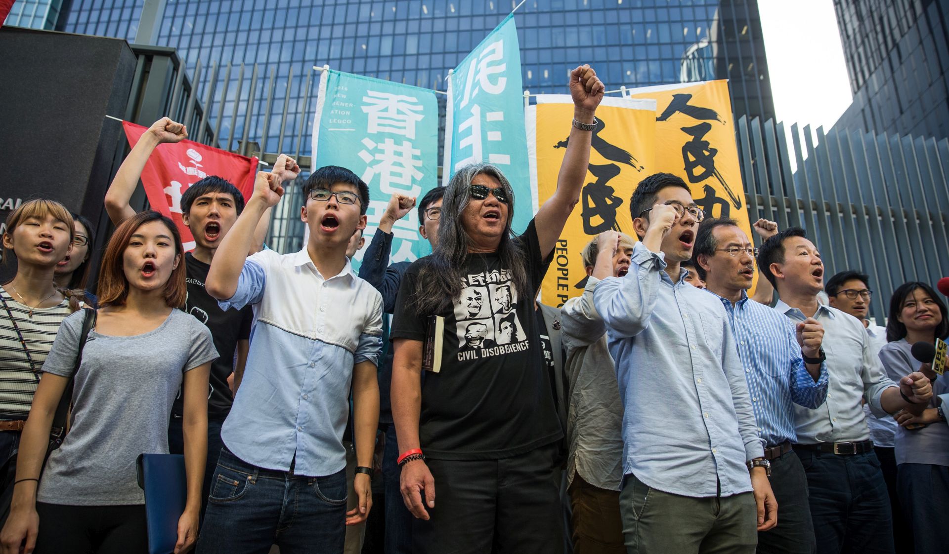 epa06057612 Democracy activists who were detained on 28 June during the protest in Golden Bauhinia Square and following their release, attend a protest in front of the Legislative Council building in Hong Kong, China, 30 June 2017. Activists demanded an explanation on why they were arrested on 28 June during the protest in Golden Bauhinia Square.  EPA/ROMAN PILIPEY