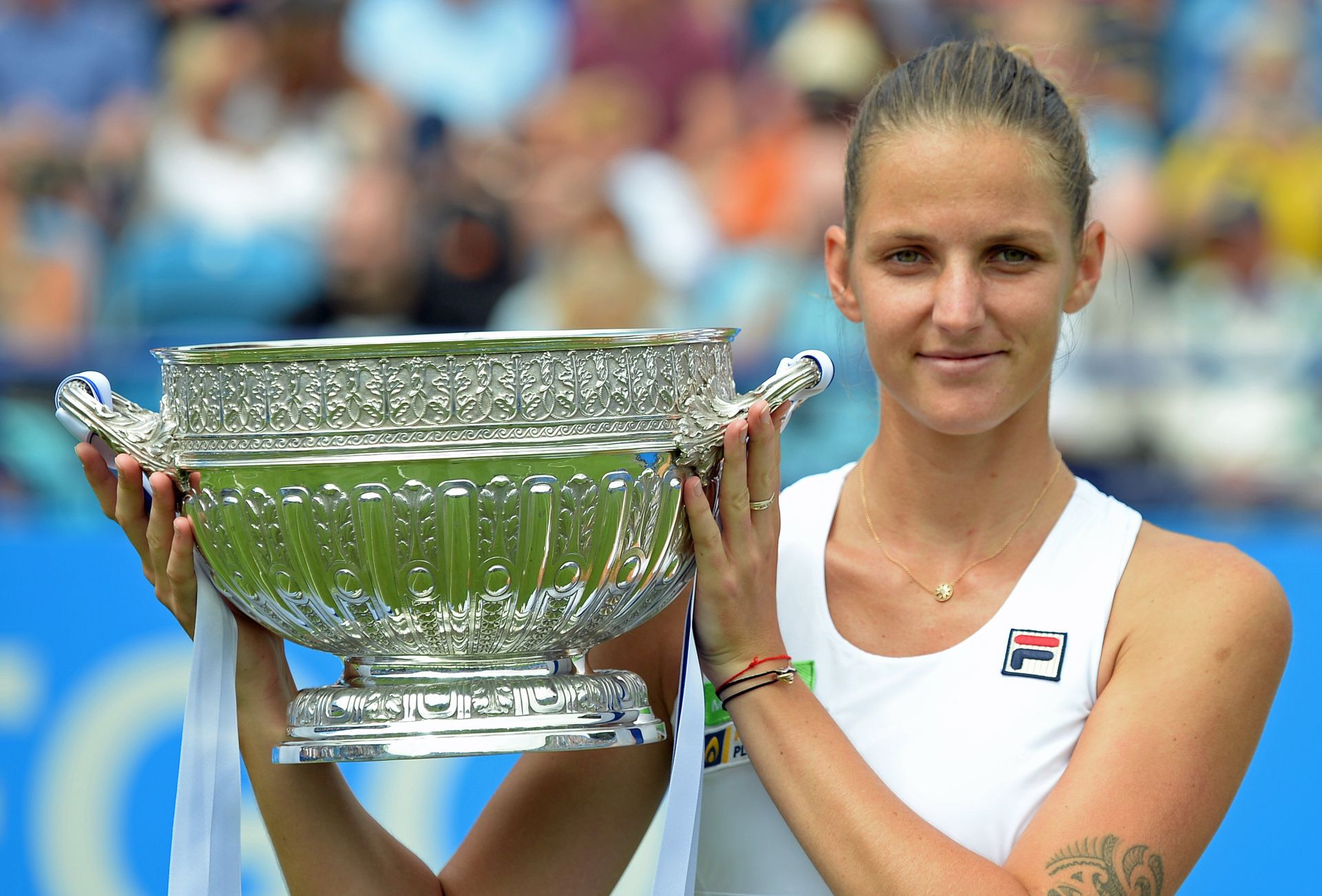 epa06059640 Karolina Pliskova of the Czech Republic lifts the trophy after winning the final match against Caroline Wozniaki of Denmark at the Aegon International tennis tournament in Eastbourne, Britain, 01 July 2017.  EPA/GERRY PENNY