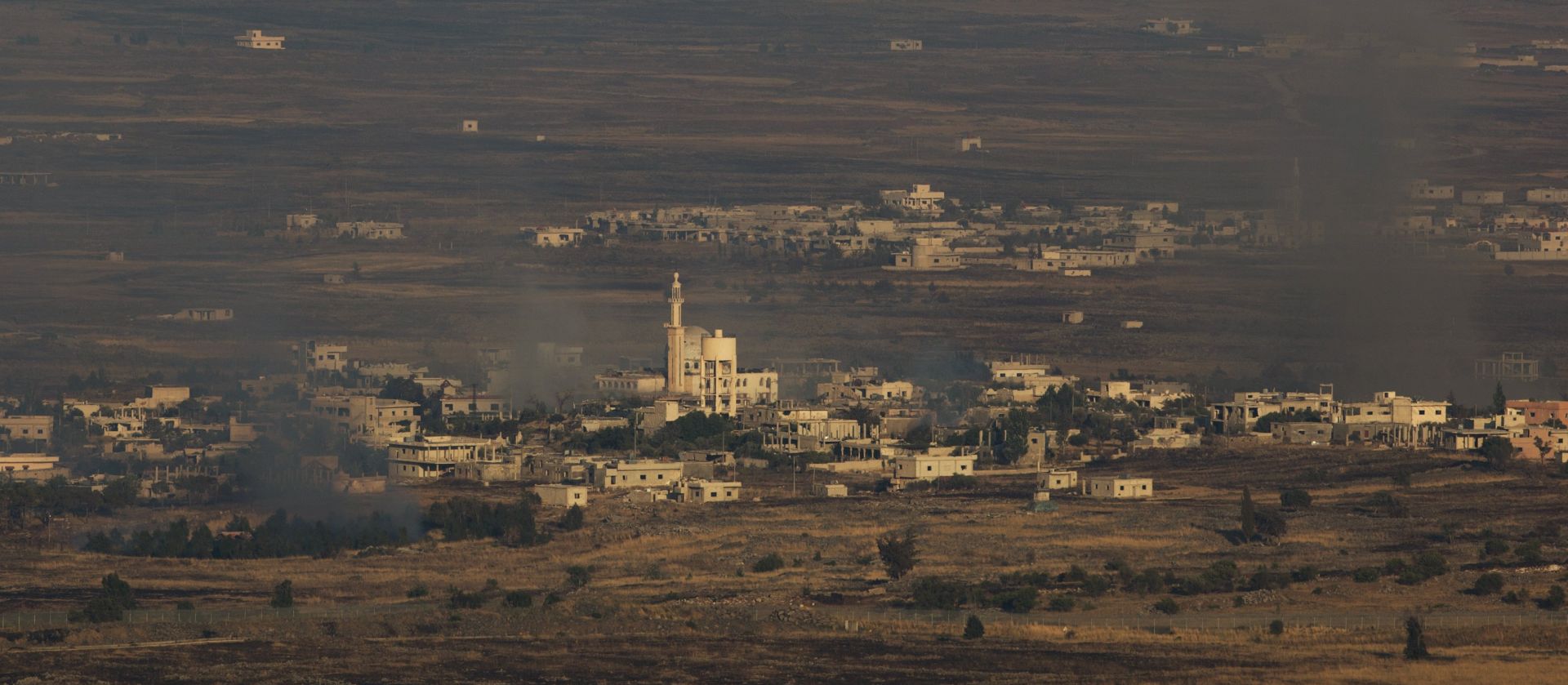 epa06060705 Smoke rise from Syrian village Hamideah as a result of fighting next to the Israeli-Syrian border in the Golan Heights, 01 July 2017. Another mortar shells fired from Syria lands hit the Isreali teritory in Golan Heights on 01 July. No injuries were reported.  EPA/ATEF SAFADI