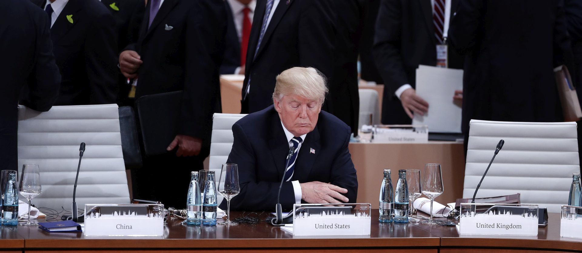 epa06072834 US President Donald J. Trump (C) sits alone at the beginning of the plenary session of the G20 summit in Hamburg, Germany, 07 July 2017. The G20 Summit (or G-20 or Group of Twenty) is an international forum for governments from 20 major economies. The summit is taking place in Hamburg 07 to 08 July 2017.  EPA/FELIPE TRUEBA