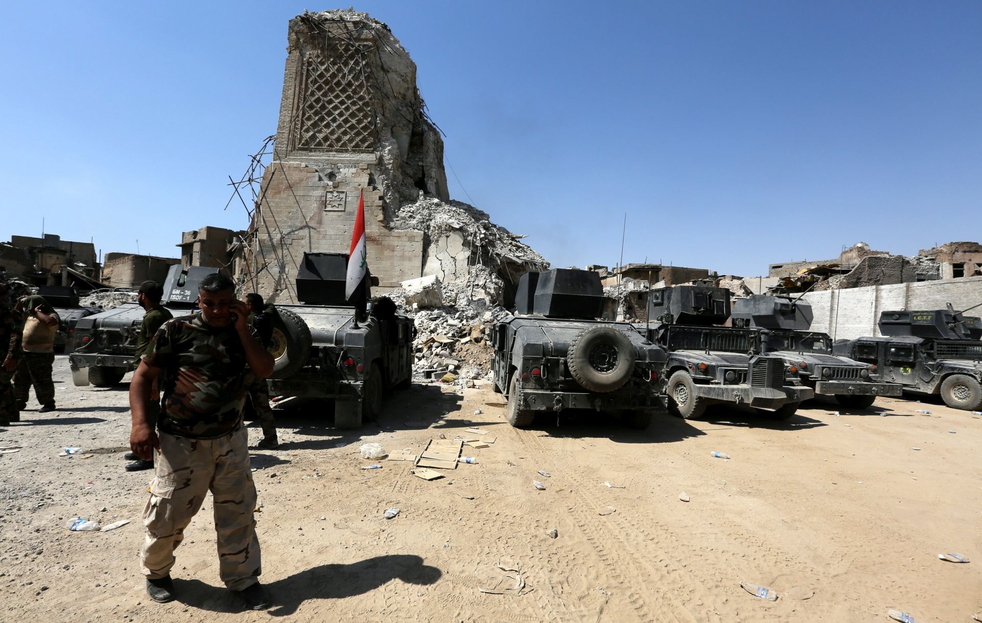 epa06068255 Iraqi security forces gather next to the destroyed Great Mosque of al-Nuri and Mosul's iconic al-Habda' minaret in the old city area, western Mosul, Iraq, 05 July 2017. Iraqi security forces are in the final stages of the battle to retake Mosul, in an operation that was launched more than eight months ago. On 04 July, 2014 Abu Bakr al-Baghdadi, the leader of the Sunni extremist group IS appeared for the first time in public at a mosque in old city area western Mosul, to declared the caliphate.  EPA/AHMED JALIL