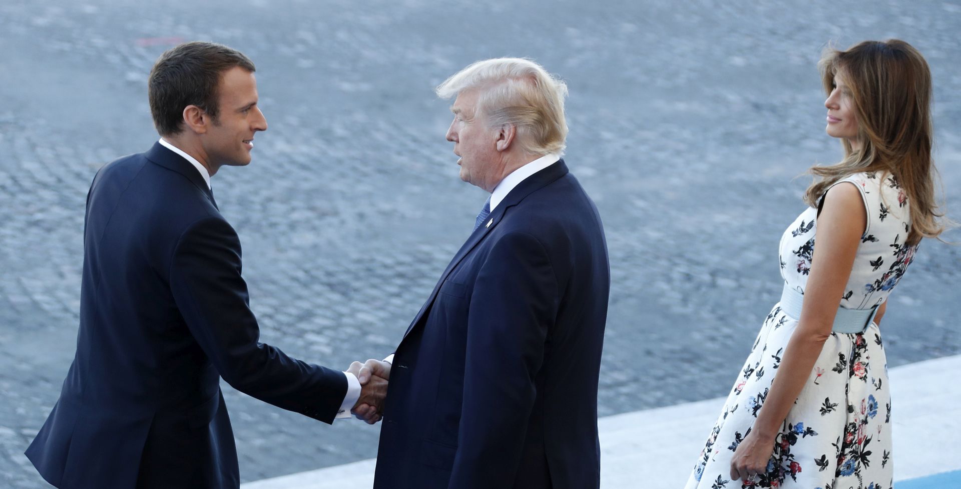 epa06086369 French President Emmanuel Macron (L), US President Donald J. Trump (C) and First Lady Melania Trump (R) arrive at the traditional military parade as part of the Bastille Day celebrations in Paris, France, 14 July 2017. The Bastille Day, the French National Day, is held annually on 14 July to commemorate the storming of the Bastille fortress in 1789.  EPA/IAN LANGSDON