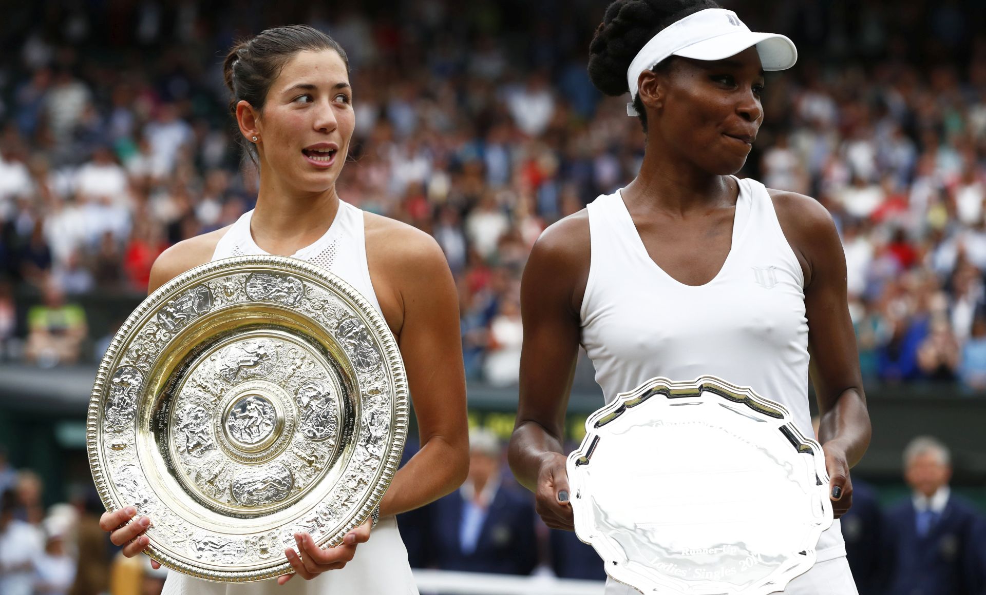epa06089384 Garbine Muguruza of Spain with the championship trophy following her victory over Venus Williams of the US (R) in the women's final of the Wimbledon Championships at the All England Lawn Tennis Club, in London, Britain, 15 July 2017.  EPA/NIC BOTHMA EDITORIAL USE ONLY/NO COMMERCIAL SALES