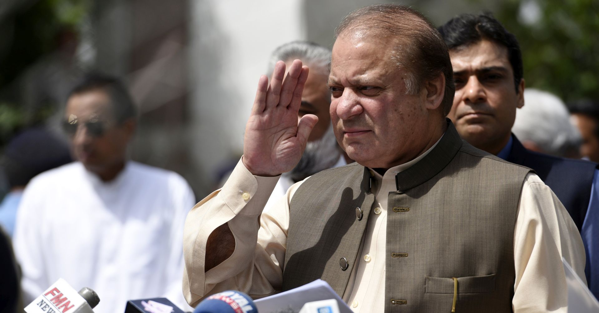 epa06113960 (FILE) - Pakistan Prime Minister Nawaz Sharif (C) talks with journalists after appearing before an investigation team formed by the Supreme Court of Pakistan to investigate the Sharif family's offshore properties that appeared in Panama papers, in Islamabad, Pakistan, 15 June 2017 (reissued 28 July 2017). According to media reports, the Pakistani Supreme Court on 28 July 2017 disqualified Prime Minister Nawaz Sharif from holding public office, ordering the National Accountability Bureau (NAB) to file reference in the Panama Leaks case that accused Prime Minister Nawaz Sharif and his family for alleged involvement in massive Panama Papers scandal in 2016.  EPA/T. MUGHAL