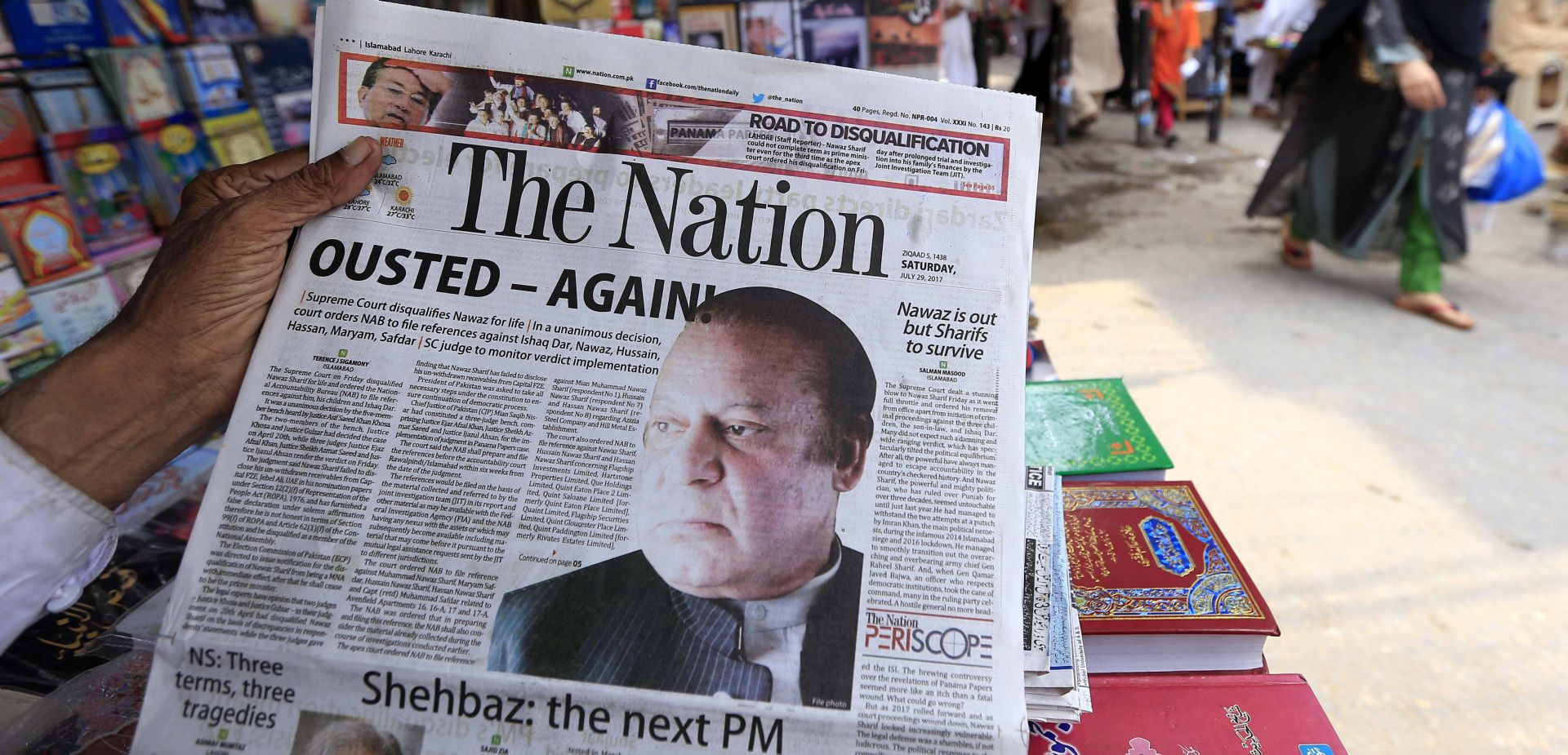 epa06115864 An obscured person reads a newspaper with a news article on the disqualification of the Pakistani Prime Minister Nawaz Sharif by the Supreme Court, in Peshawar, Pakistan, 29 July 2017. Pakistani Prime Minister Nawaz Sharif stepped down on 28 July following the Supreme Court's decision to disqualify him from holding public office over his links to the so-called 'Panama Papers' corruption scandal. The court further ordered the National Accountability Bureau (NAB), the anti-corruption body, to open an investigation into Sharif, his children Hasan, Husain and Maryam, Maryam's husband Mohamed Safdar Awan and Finance Minister Ishaq Dar.  EPA/ARSHAD ARBAB