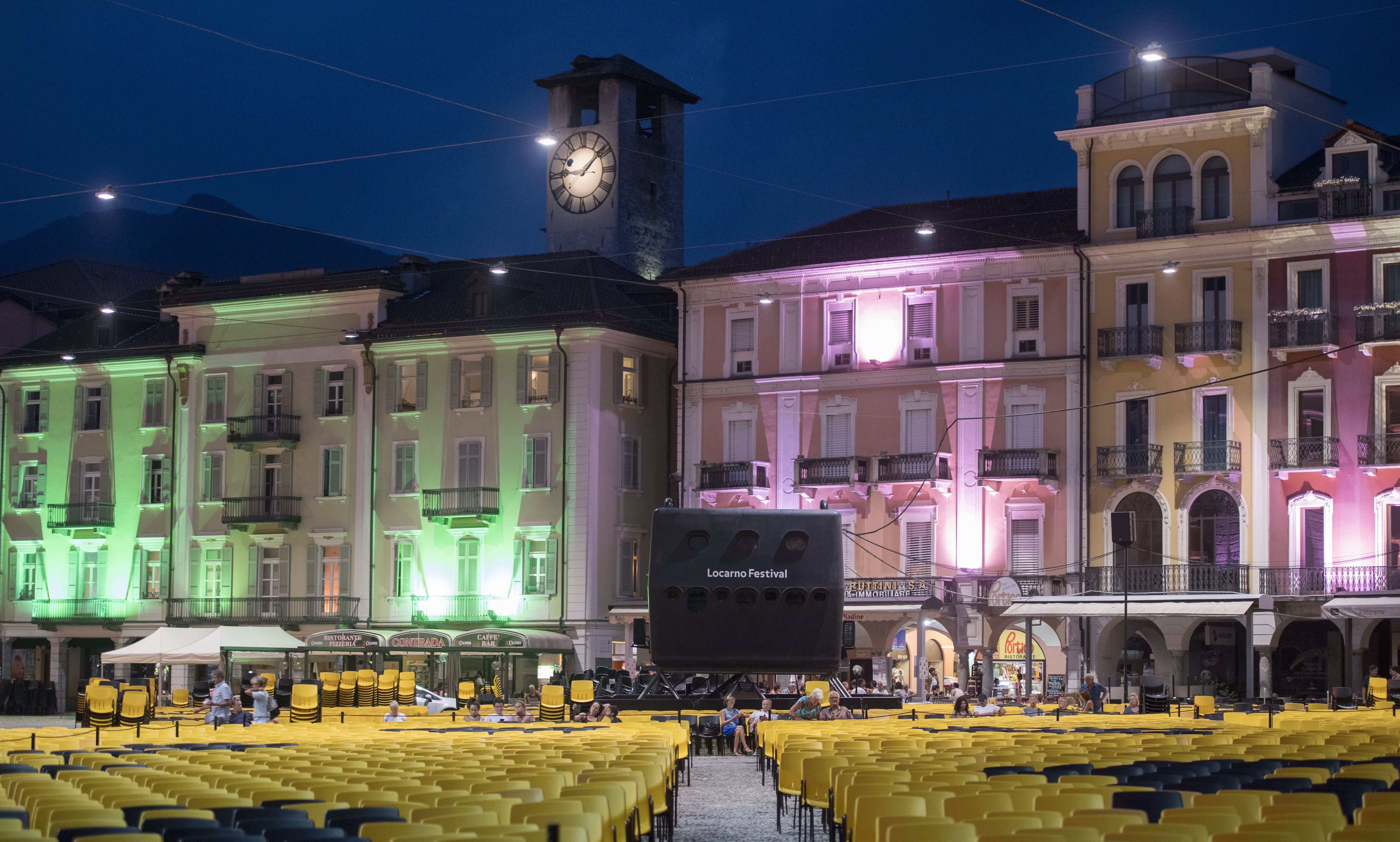 epa06120394 A general view at dusk of the Piazza Grande with hundreds of yellow and black chairs at the 70th Locarno International Film Festival in Locarno, Switzerland, 01 August 2017.  EPA/URS FLUEELER