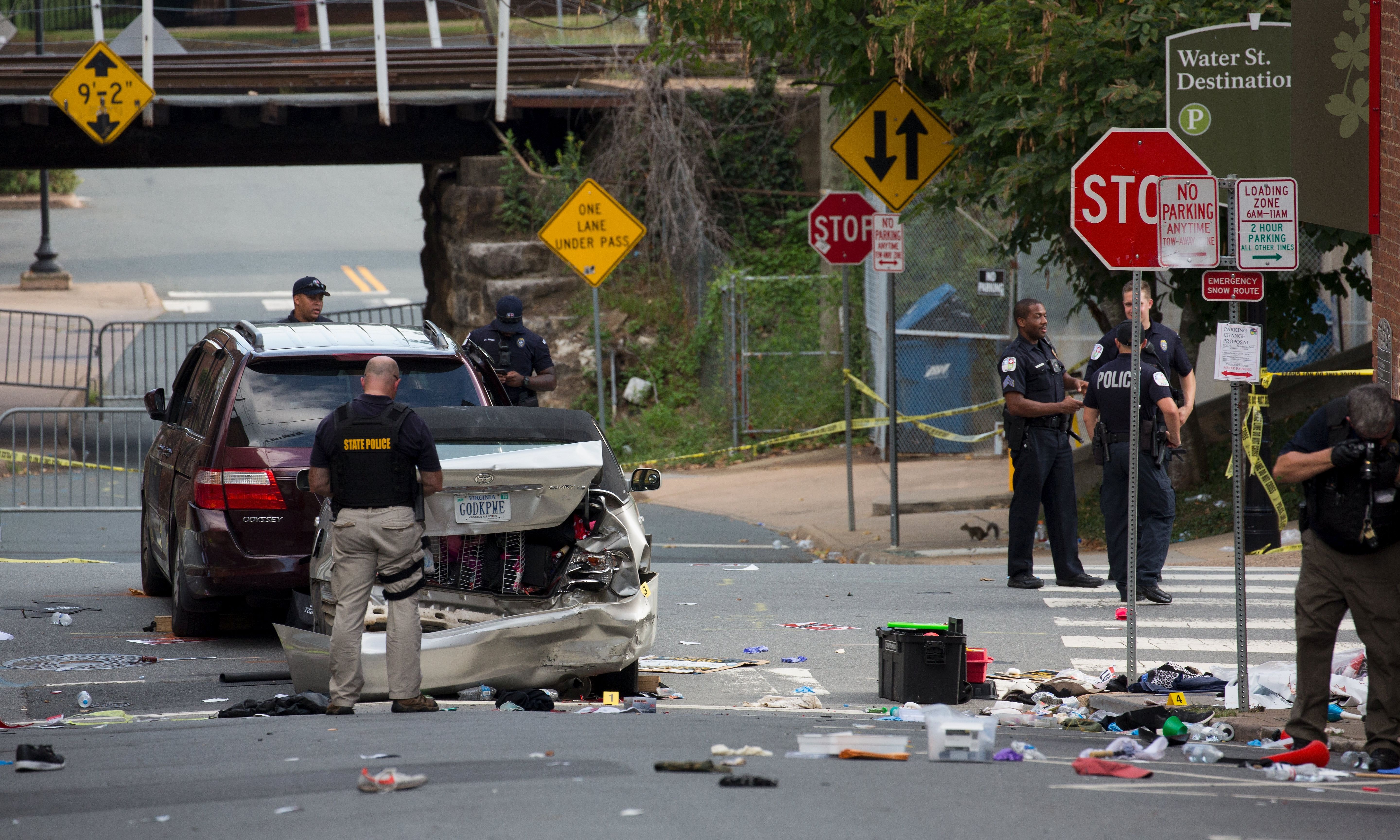 epa06141385 Virginia State Police inspect the site where a vehicle hit protesters in Charlottesville, Virginia, USA, 12 August 2017. According to media reports at least one person was killed and 19 injured after a car hit a crowd of people counter-protesting the 'Unite the Right' rally which was scheduled to take place in Charlottesville on 12 August. At least 15 others were injured in clashes during protests.  EPA/TASOS KATOPODIS