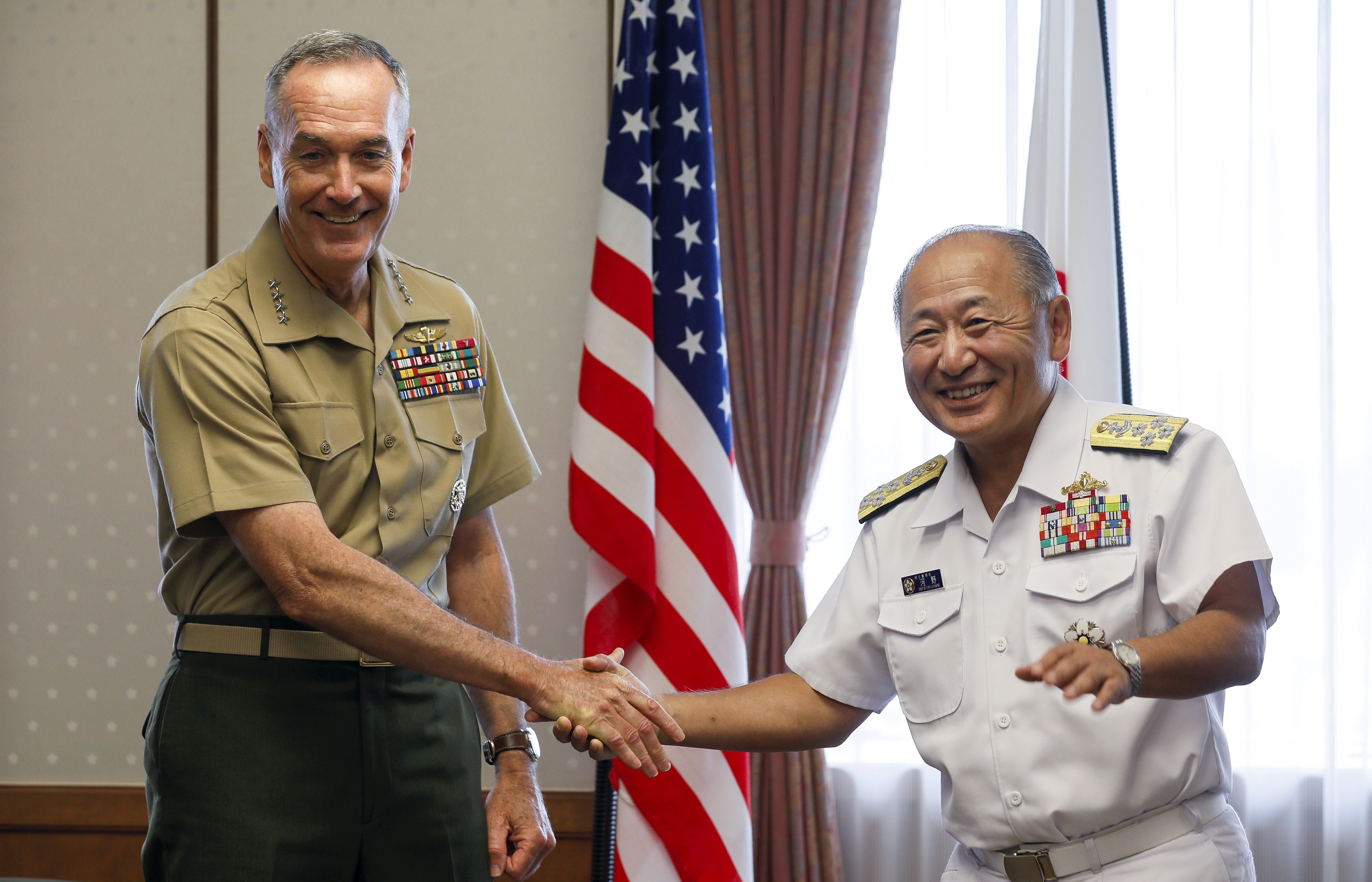 epa06149355 General Joseph F. Dunford, Jr. (L), US Chairman of Joint Chiefs of Staff, shakes hands with Japan's Chief of Staff, Joint Staff Katsutoshi Kawano (R) at the start of their talks at the Defense Ministry in Tokyo, Japan, 18 August 2017.  EPA/KIMIMASA MAYAMA / POOL