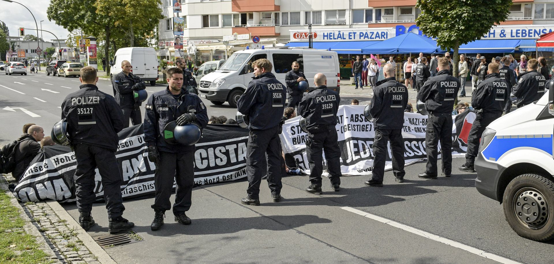 epa06151018 Counter-protesters block a street as they attend a demonstration against a gathering of far-right organisations commemorating the 30th death anniversary Rudolf Hess in the district of Spandau in Berlin, Germany, 19 August 2017. Hess died on 17 August 1987 after committing suicide in the Spandau Prison, where he served his life sentence. Hess was one of the most prominent Nazi leaders and appointed Deputy Fuehrer by German dictator Adolf Hitler in 1933.  EPA/ALEXANDER BECHER