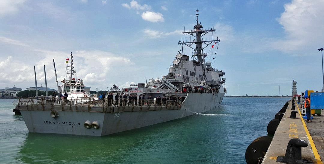 epa06154665 A handout photo made available by the United States Navy 7th Fleet shows the United States Navy missile destroyer USS John S. McCain as it berths towards a pier at the Changi Navy Base in Singapore, 21 August 2017. According to media reports, ten US Navy sailors are missing and five were injured after the guided-missile destroyer USS John S. McCain collided with the Liberian-flagged oil tanker Alnic MC off the coast between Singapore and Malaysia.  EPA/UNITED STATES NAVY 7TH FLEET/ HANDOUT  HANDOUT EDITORIAL USE ONLY/NO SALES