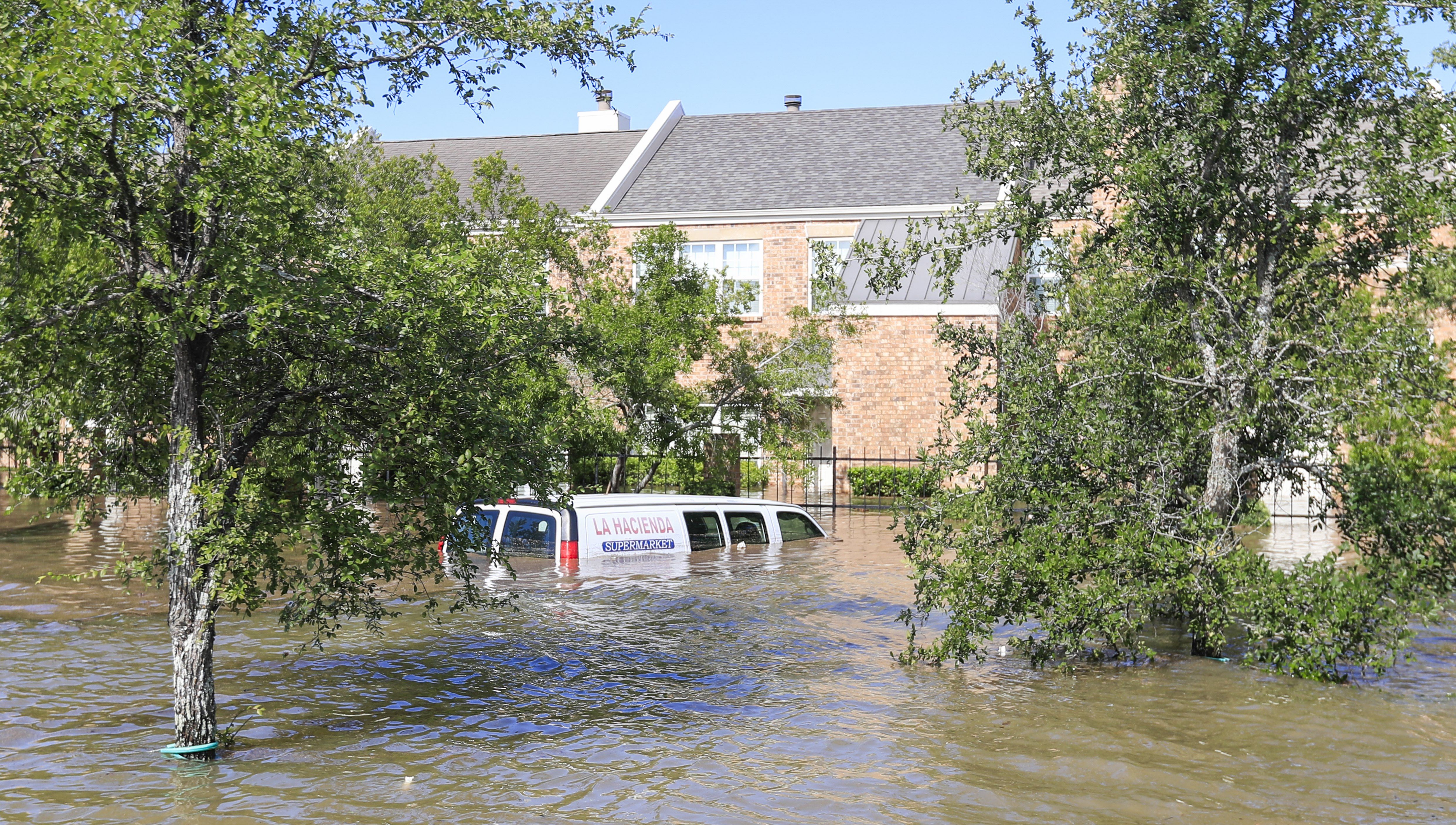 epa06172409 A submerged van sits in Buffalo Bayou floodwaters in the aftermath of Hurricane Harvey in Houston, Texas, USA, 30 August 2017. Hurricane Harvey made landfall on the south coast of Texas as a major hurricane category 4. The last time a major hurricane of this size hit the United States was in 2005.  EPA/TANNEN MAURY