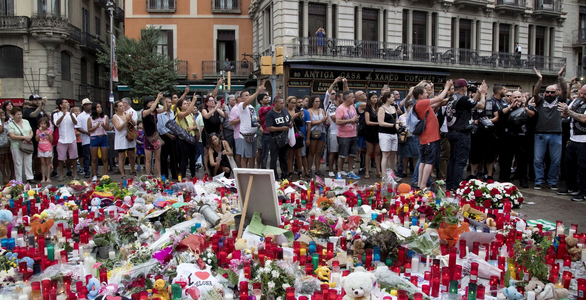 epa06151145 People pay tribute to victims outside the Liceu Theatre, on the site of a deadly van attack in Barcelona, Spain, 19 August 2017, just two days after the terrorist attack in the Spanish city. At least 14 people were killed and some 130 others injured after cars crashed into pedestrians on the La Rambla boulevard in Barcelona and on a promenade in the coastal city of Cambrils on 17 August. Spanish police have stated that the attacks in Barcelona and in Cambrils were linked. The so-called 'Islamic State' (IS) in the meantime has claimed responsibility for the attacks in Barcelona and Cambrils. Spanish police are still hunting for the driver of a van who perpetrated the deadly attack in Barcelona.  EPA/MARTA PEREZ
