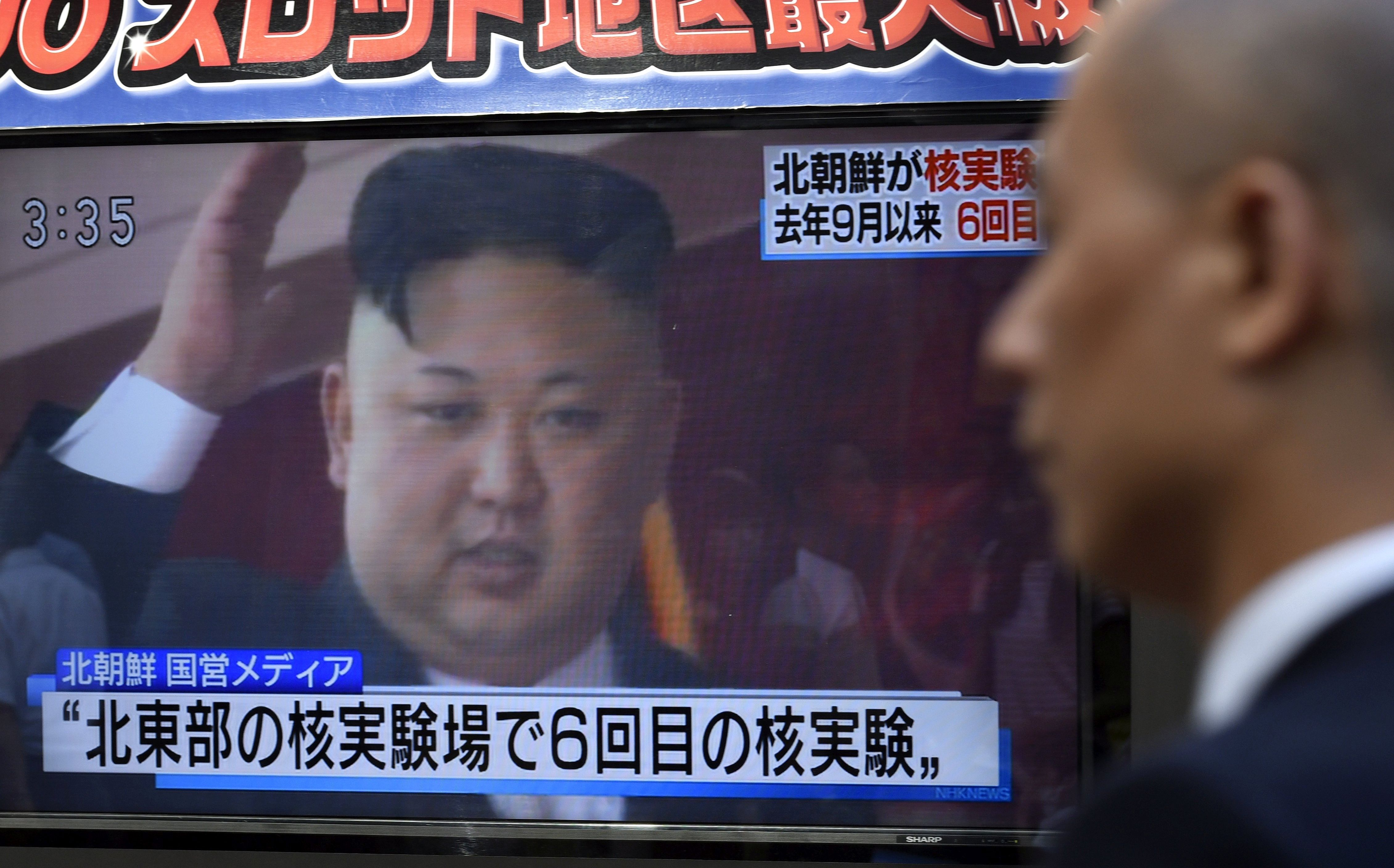 epa06180519 A pedestrian walks past a TV screen on a street displaying North Korean leader Kim Jong-un after North Korea proceeded to a nuclear test, in Tokyo, Japan, 03 September 2017. North Korea announced it has conducted to its sixth nuclear test by detonating a hydrogen bomb that can installed in an ICBM.  EPA/FRANCK ROBICHON